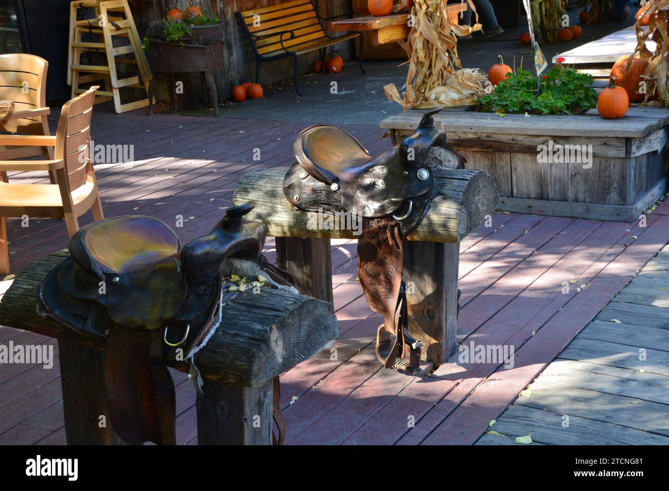 Horse saddle stools instead of benches on main street of the wild west town in Winthrop Washington. Stock Photo