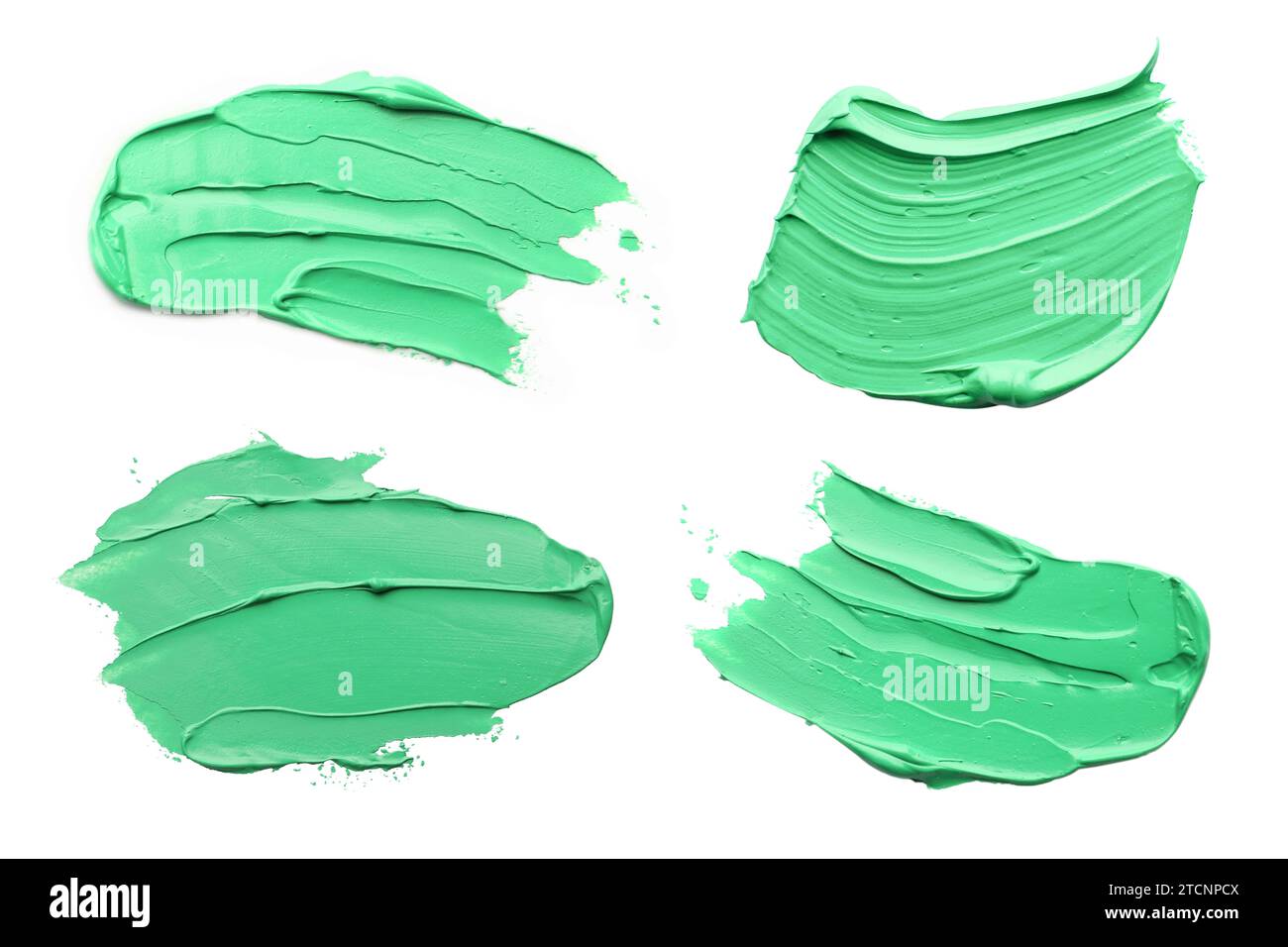 Light green oil paint strokes isolated on white, top view