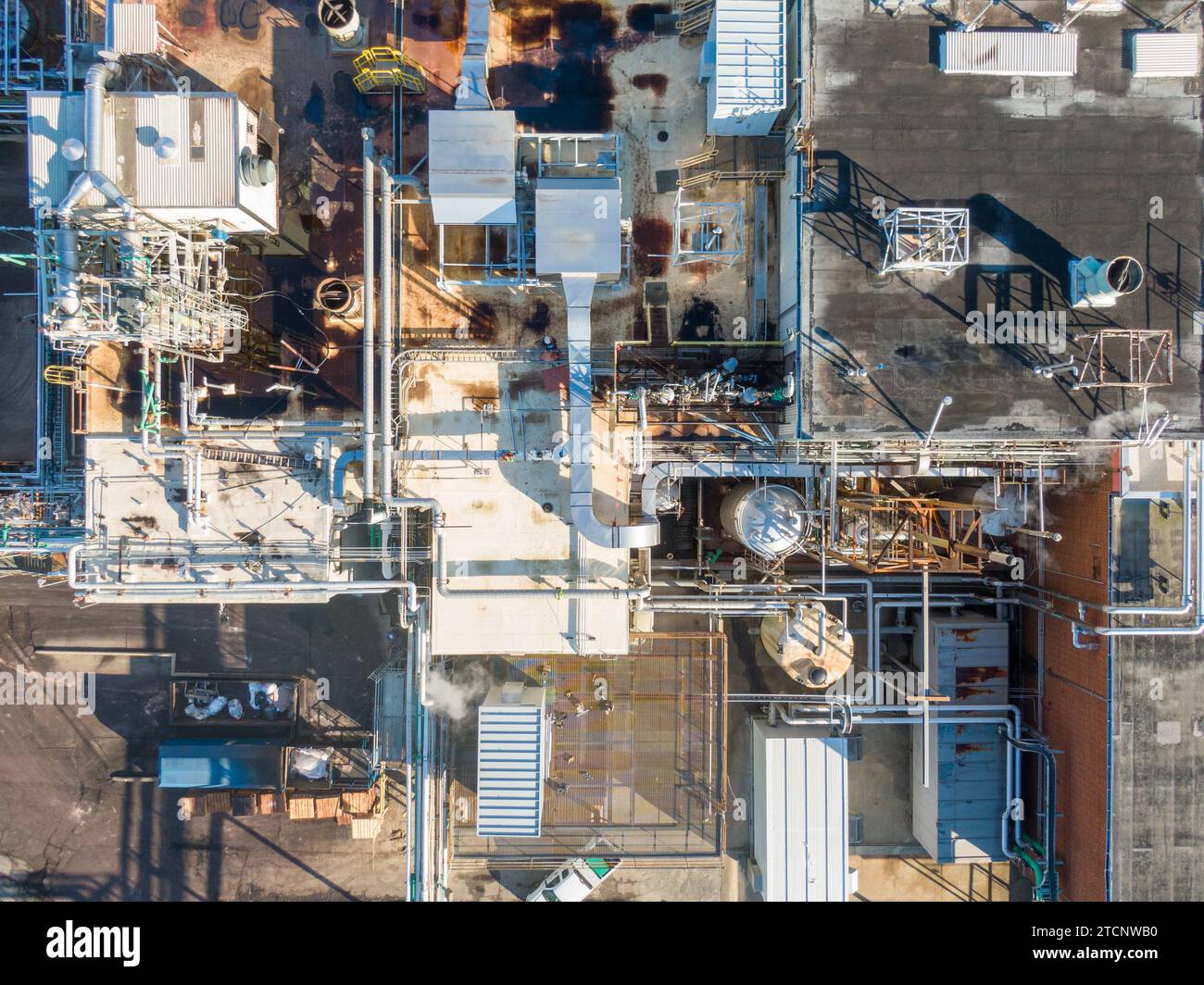 drone images of a large pharmaceutical manufacturing factory with lots of pipes, cool angles, and interesting shadows. Stock Photo