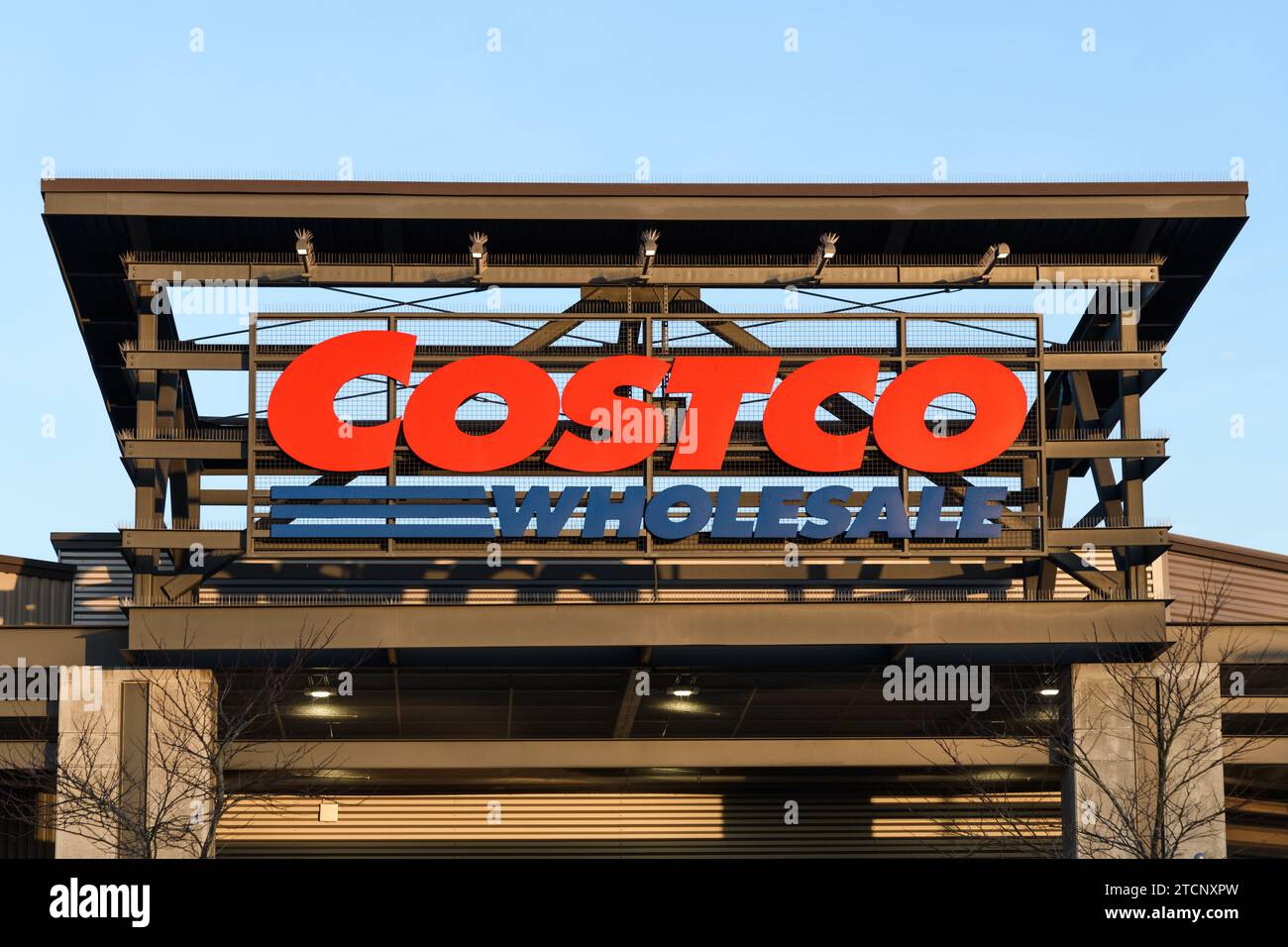 Redmond, WA, USA - February 12, 2023; Costco Wholesale sign suspended on metal fram at warehouse Stock Photo
