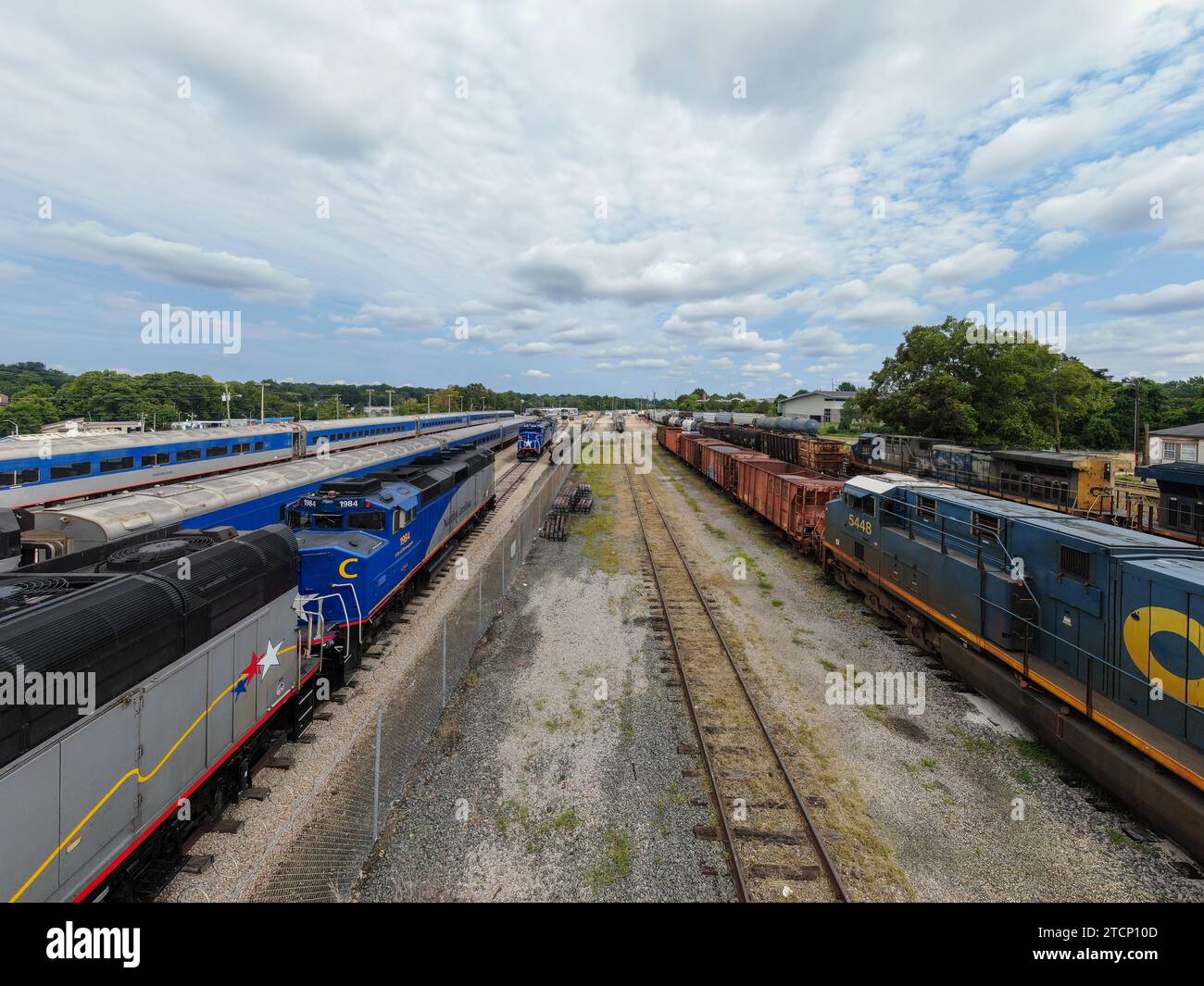 drone photos of various rail cars and amtrak trains on a cloudy day in ...