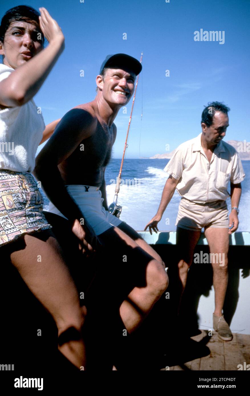 BAJA CALIFORNIA, MEXICO - JUNE, 1962:  Actor and former baseball player Chuck Connors (1921-1992) and actress fiance Kamala Devi (1934-2010) relax on a boat during a fishing trip circa June, 1962 in Baja California, Mexico.  (Photo by Hy Peskin) *** Local Caption *** Kamala Devi;Chuck Connors Stock Photo