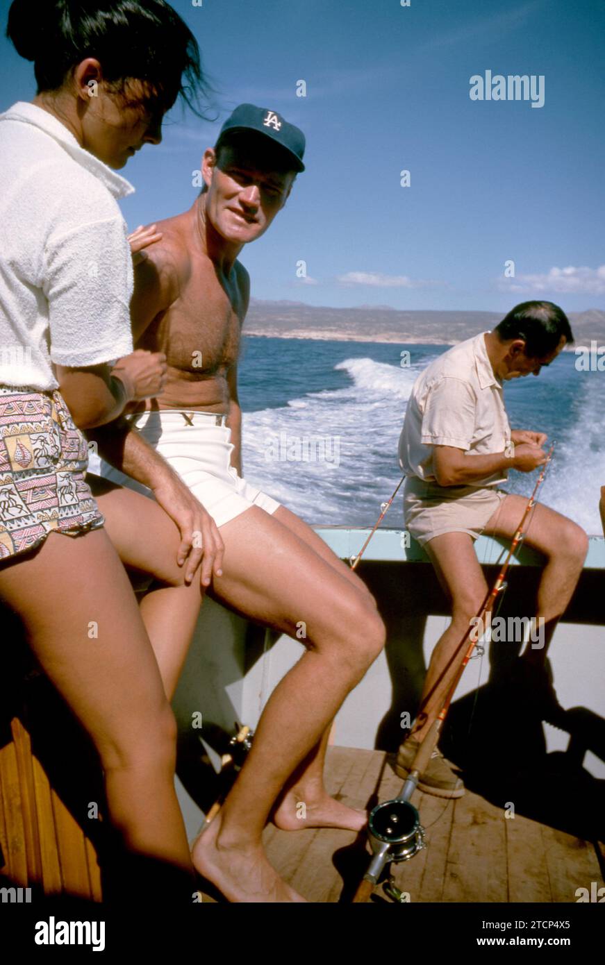 BAJA CALIFORNIA, MEXICO - JUNE, 1962:  Actor and former baseball player Chuck Connors (1921-1992) and actress fiance Kamala Devi (1934-2010) relax on a boat during a fishing trip circa June, 1962 in Baja California, Mexico.  (Photo by Hy Peskin) *** Local Caption *** Kamala Devi;Chuck Connors Stock Photo
