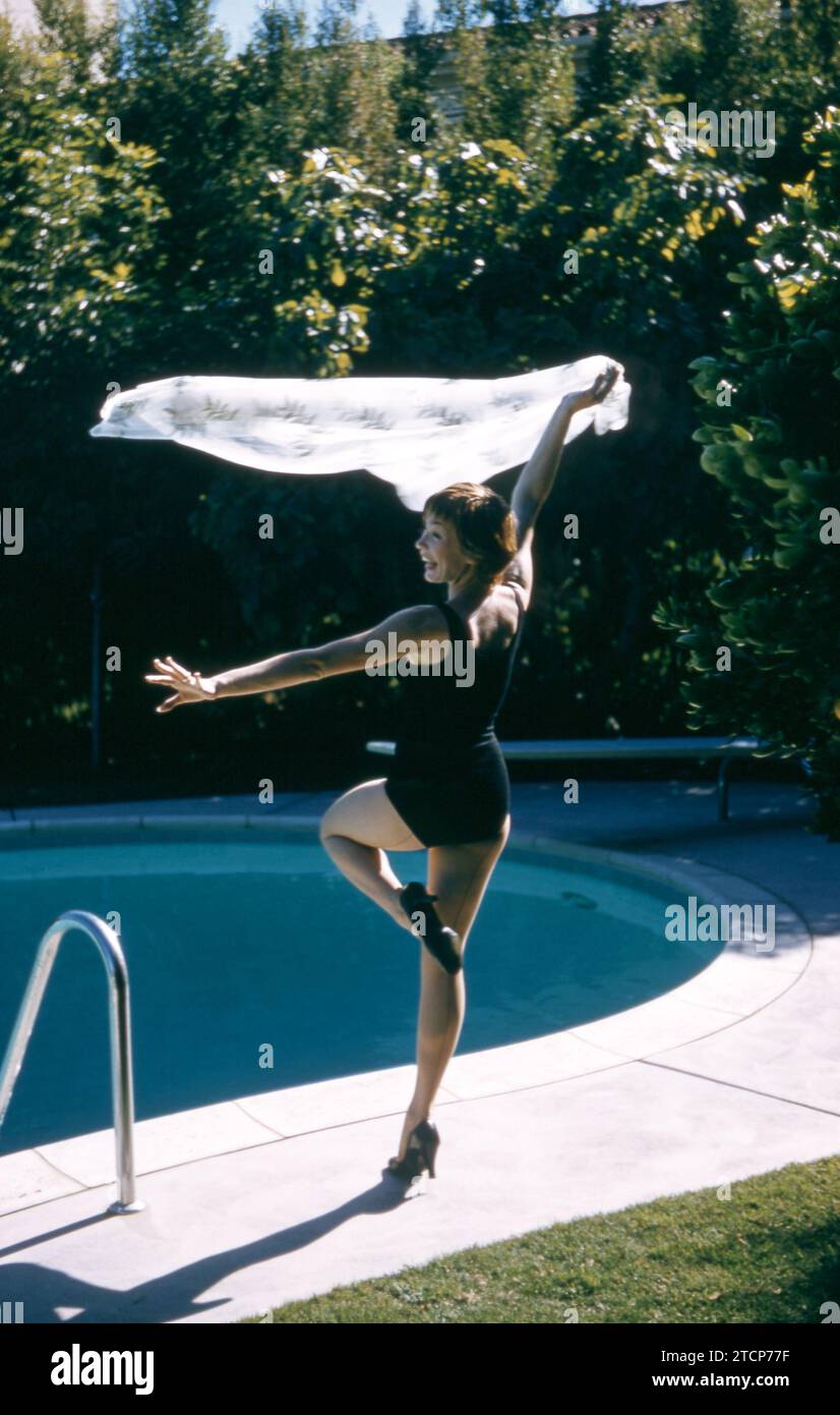 1958:  American film and television actress Shirley MacLaine poses for a portrait during a portrait session next to a swimming pool circa 1958.  (Photo by Hy Peskin) *** Local Caption *** Shirley MacLaine Stock Photo