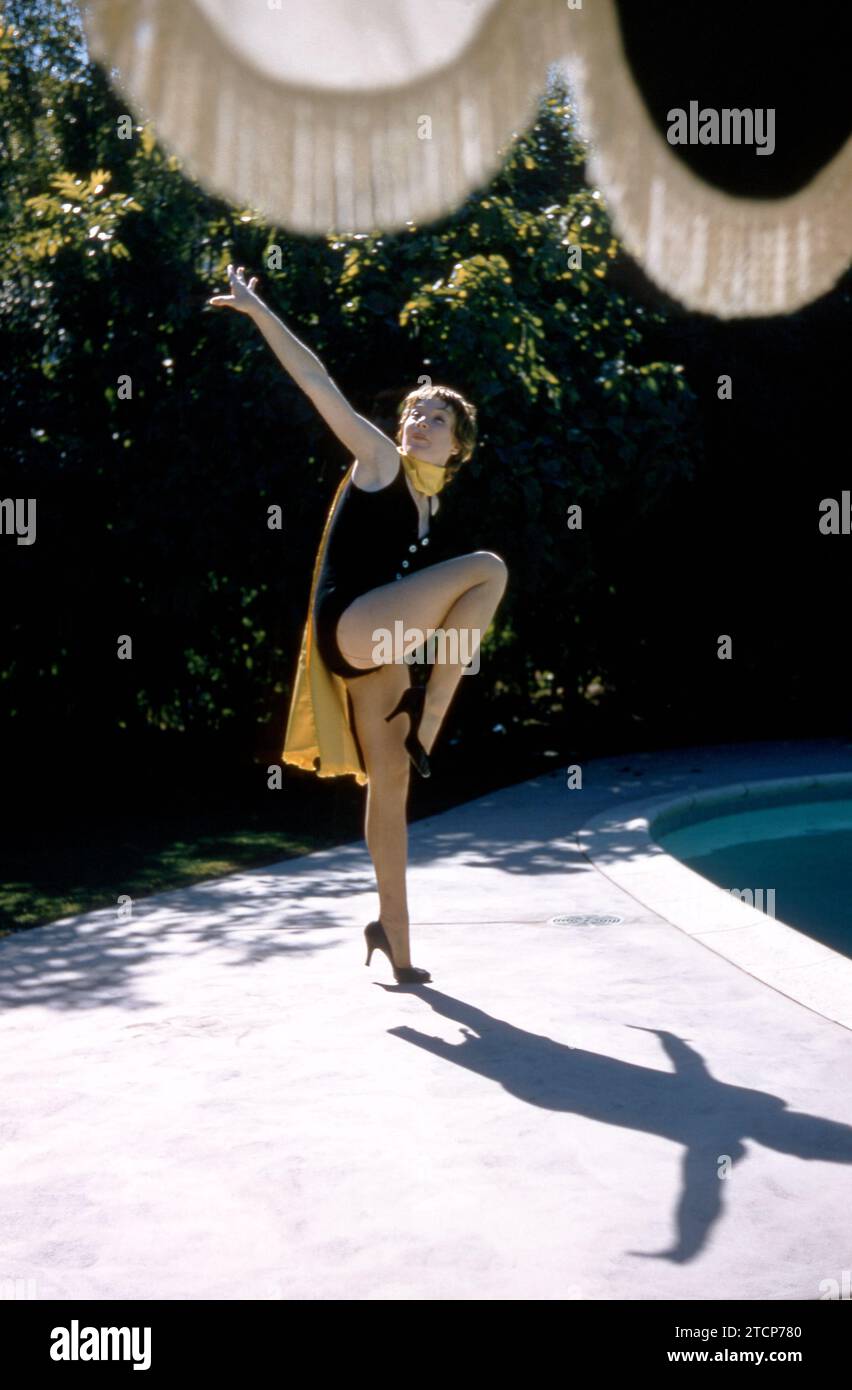 1958:  American film and television actress Shirley MacLaine poses for a portrait during a portrait session next to a swimming pool circa 1958.  (Photo by Hy Peskin) *** Local Caption *** Shirley MacLaine Stock Photo