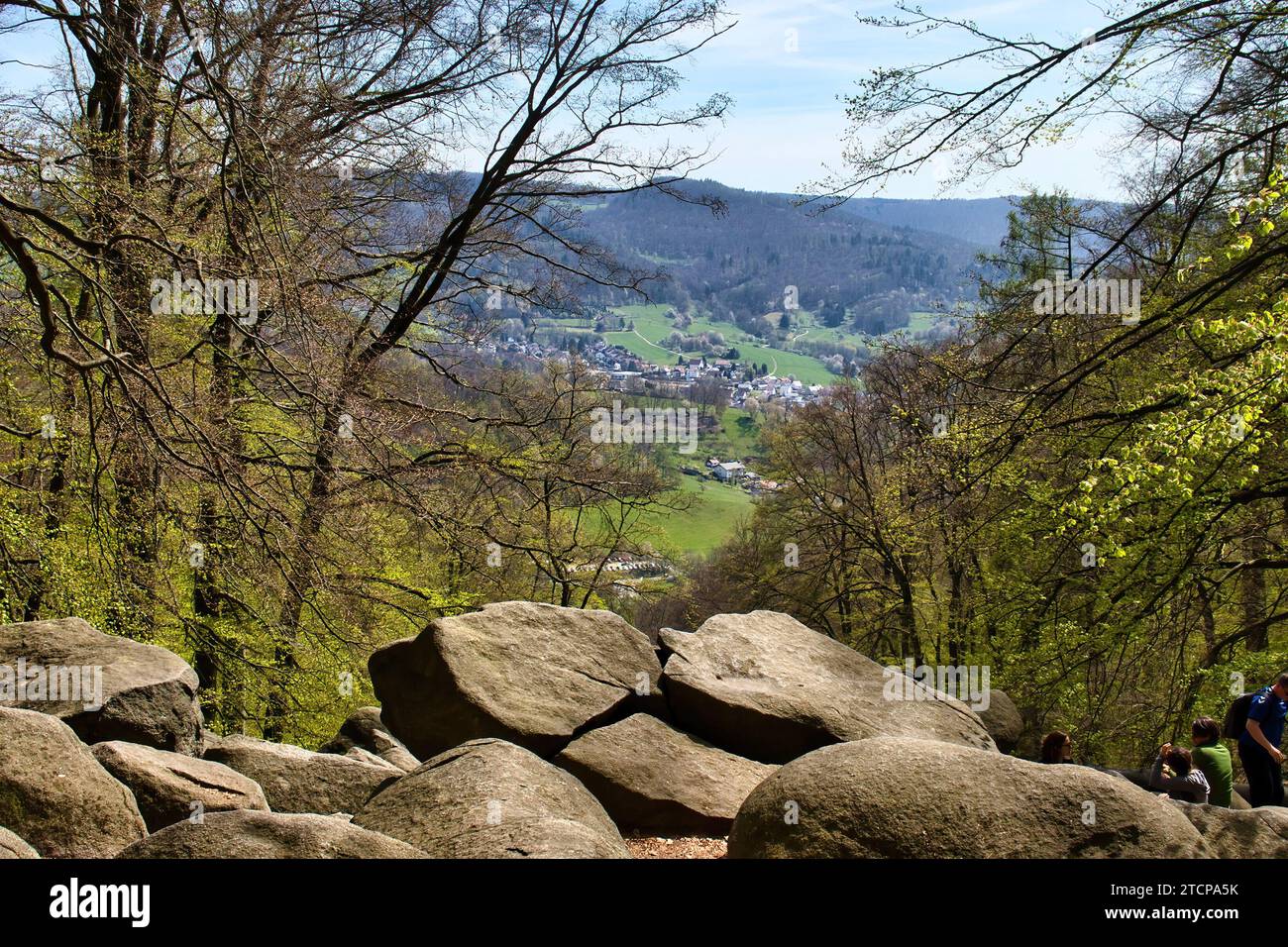 Lautertal, Germany - April 24, 2021: Rocks and trees overlooking small German village on a spring day at Felsenmeer in Germany. Stock Photo