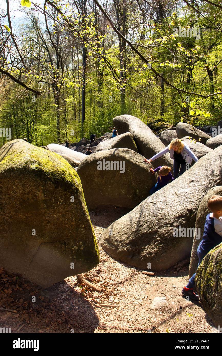 Lautertal, Germany - April 24, 2021: Large rocks on a hill in the trees on a spring day at Felsenmeer in Germany. Stock Photo
