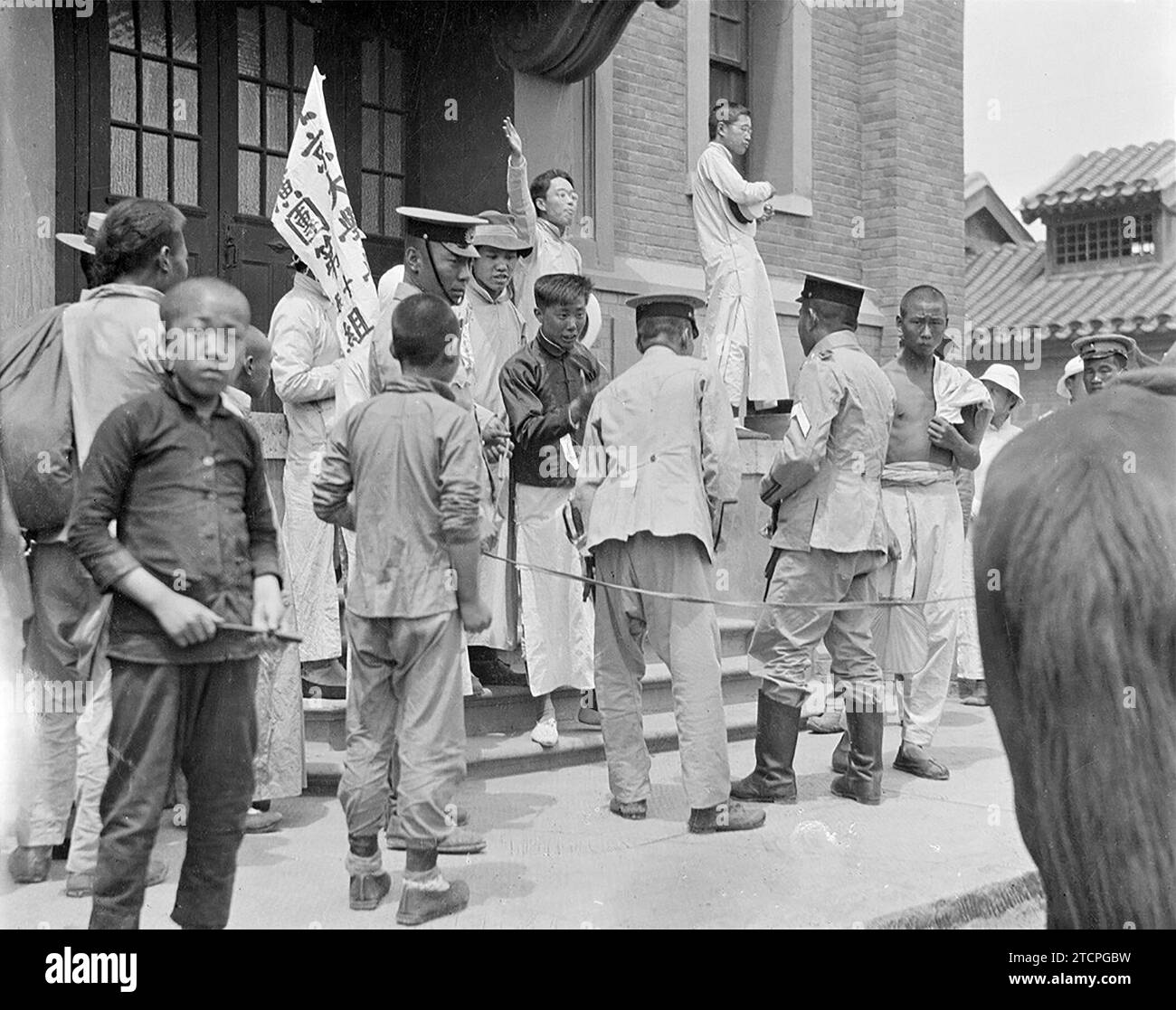 China: Revolutionary students and lecturers demonstrating at Beijing University, May 4th Movement, 1919.  The May Fourth Movement was an anti-imperialist, cultural and political movement growing out of student demonstrations in Beijing on May 4, 1919, protesting the Chinese government's weak response to the Treaty of Versailles, especially the Shandong Problem. These demonstrations sparked national protests and marked the upsurge of Chinese nationalism, a shift towards political mobilisation and away from cultural activities, and a move towards a populist base rather than intellectual elites. Stock Photo
