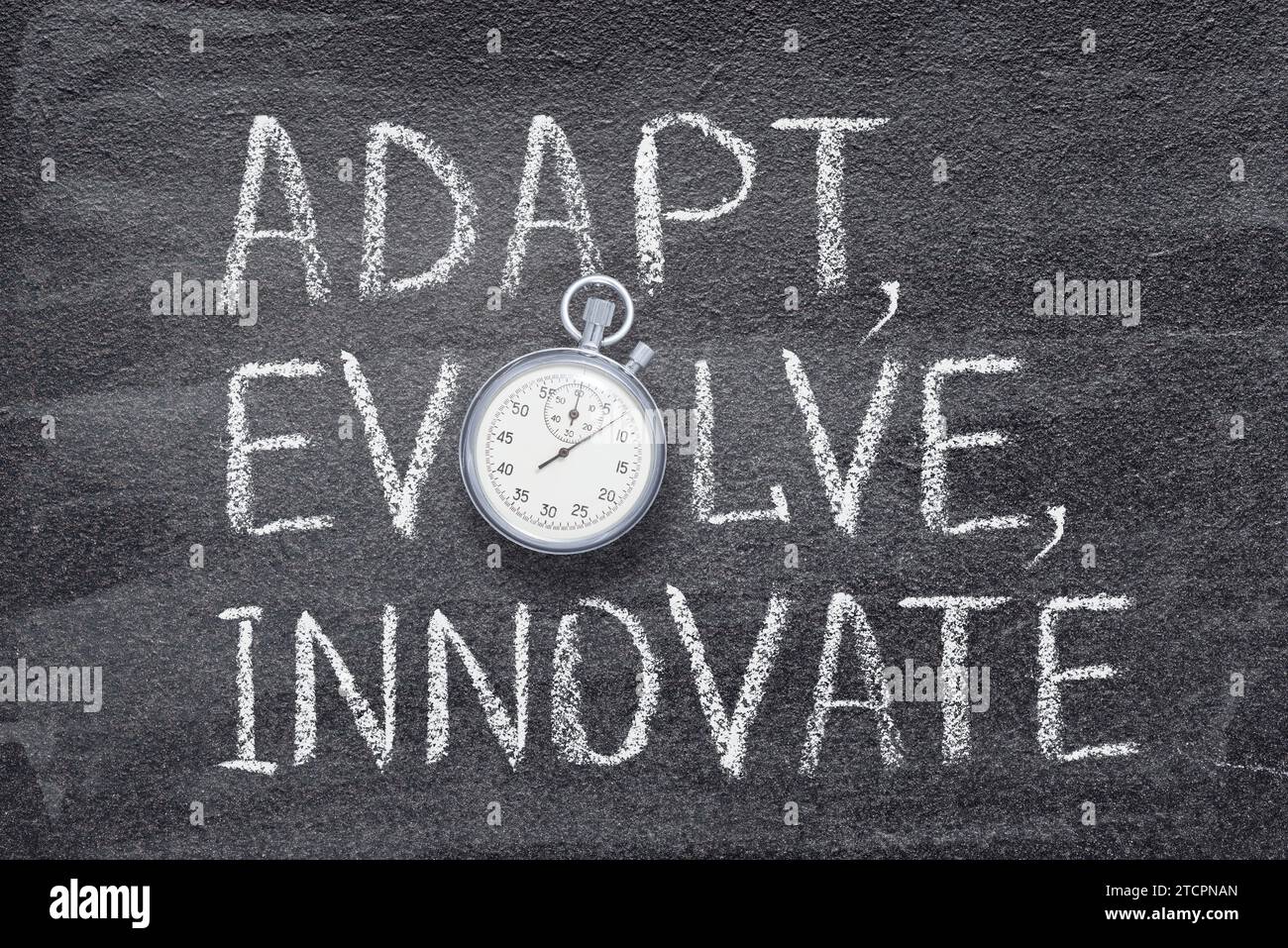 adapt, evolve, innovate phrase written on chalkboard with vintage precise stopwatch Stock Photo