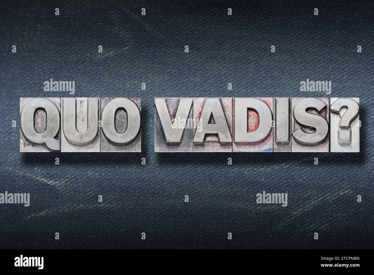 quo vadis (where are you going) question made from metallic letterpress on dark jeans background Stock Photo