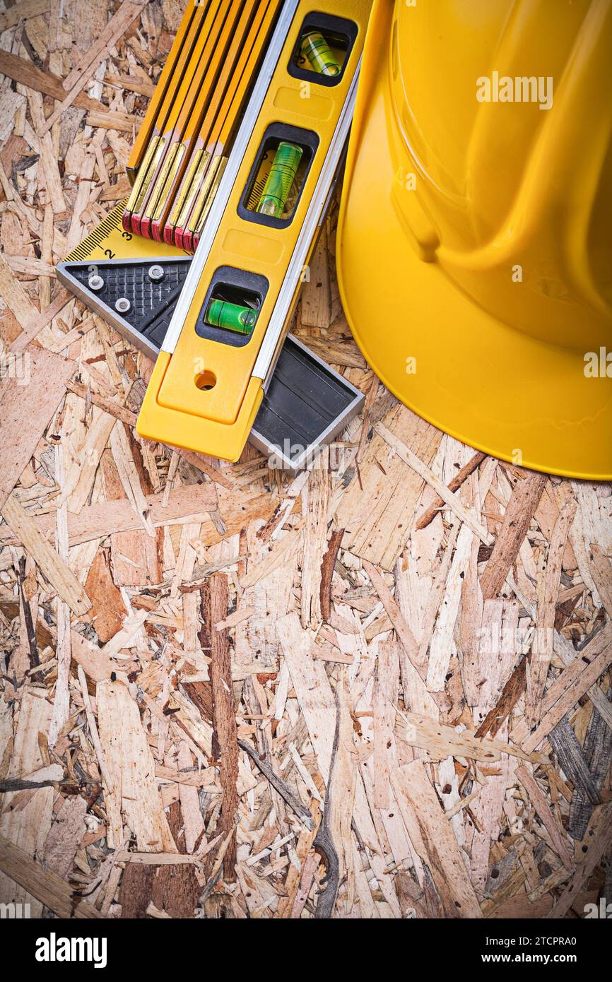 Square ruler Building level Building helmet Wooden metre on chipboard ...