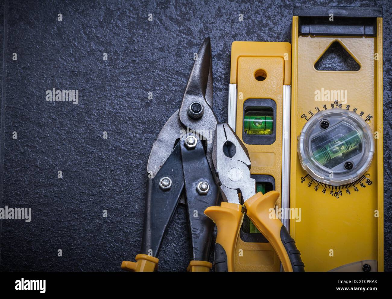 Tin snips Gripping pliers Construction plane on black background Stock