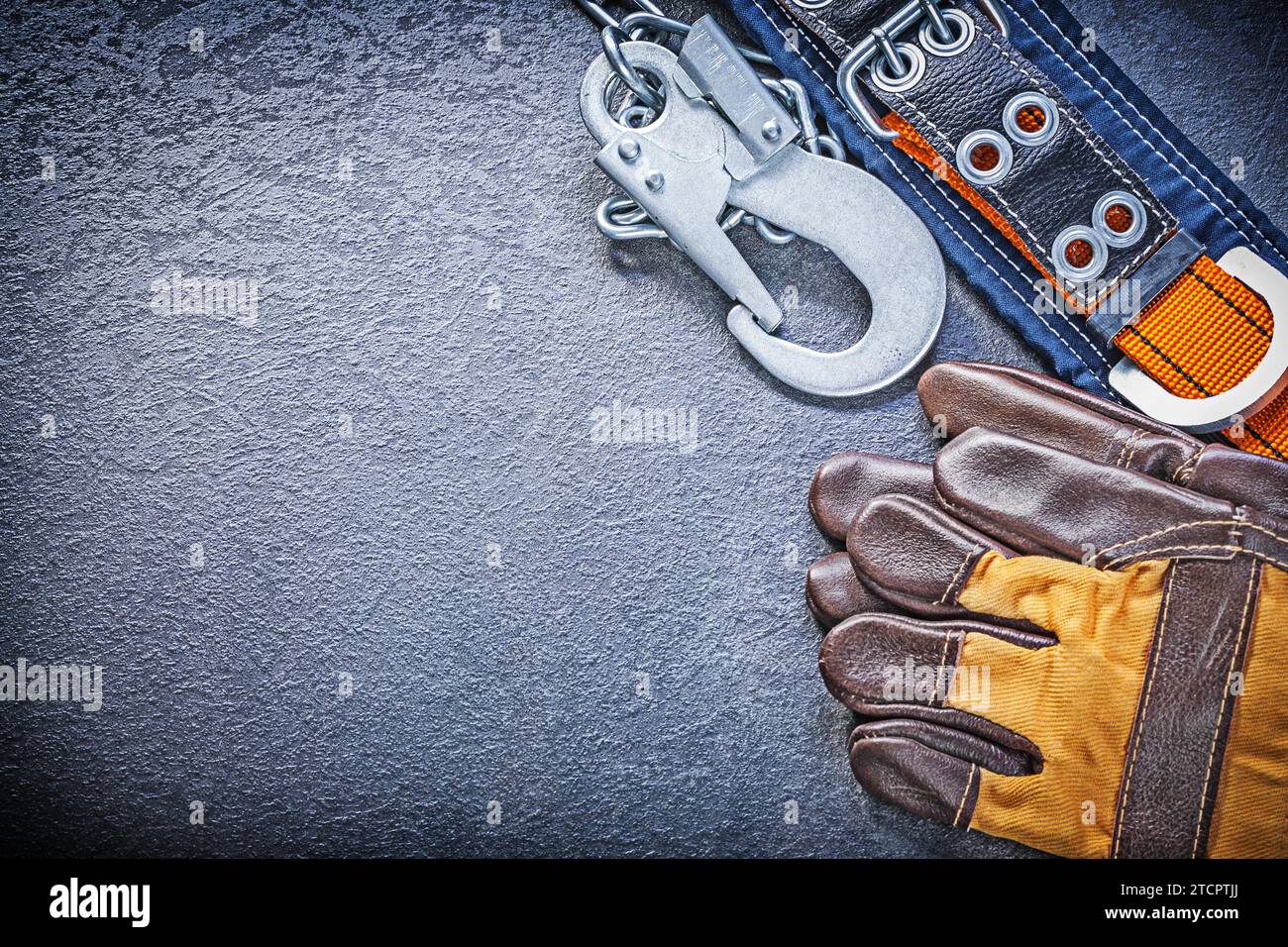Construction body belt protective gloves on black background maintenance concept Stock Photo