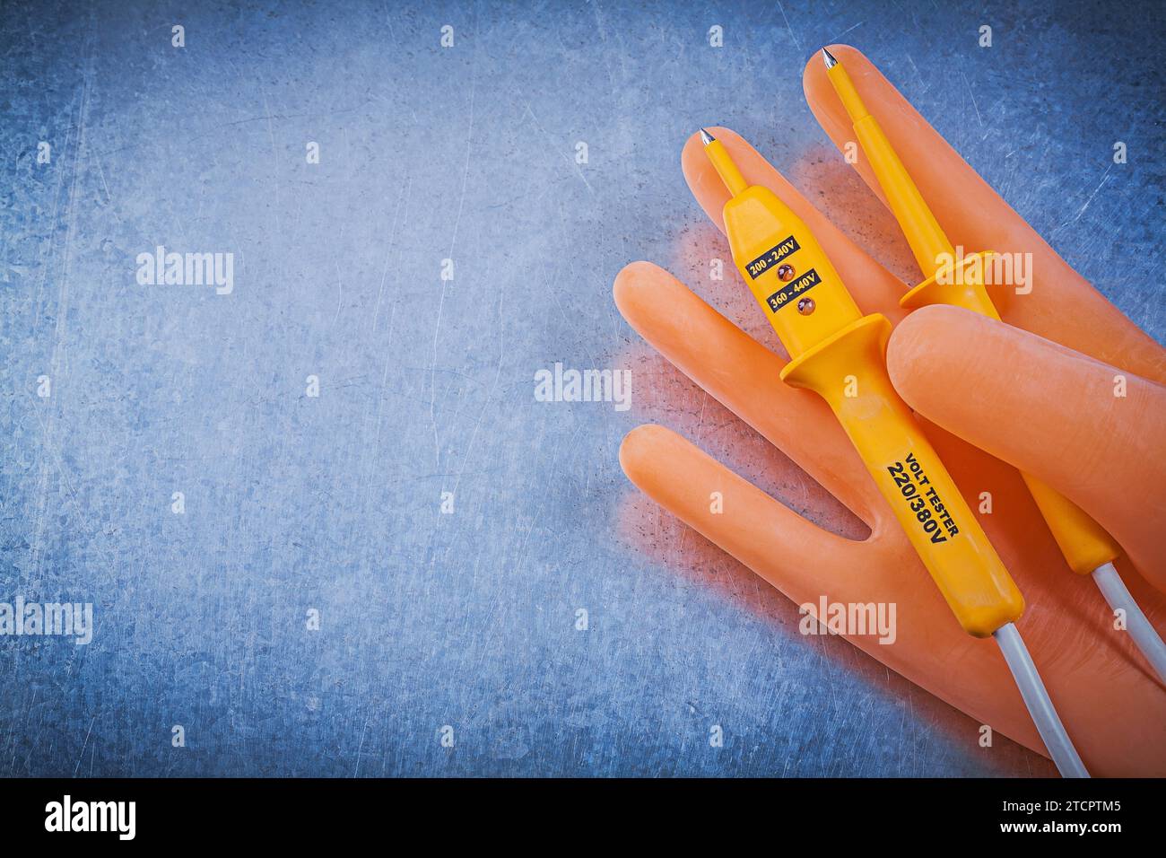 Dielectric rubber gloves Electrical test device on metallic background