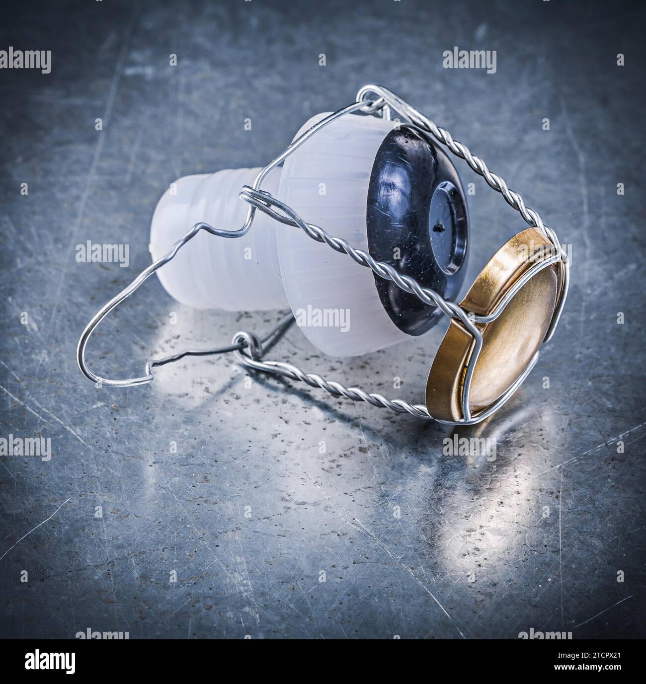 Plastic cork tap with twisted wire on a metallic background Stock Photo