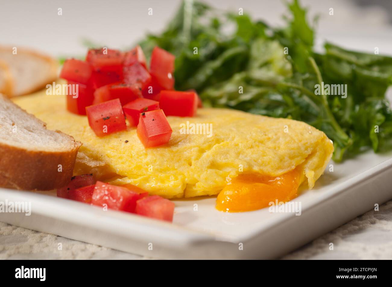 Home made omelette with cheese tomato and rucola rocket salad arugola Stock Photo