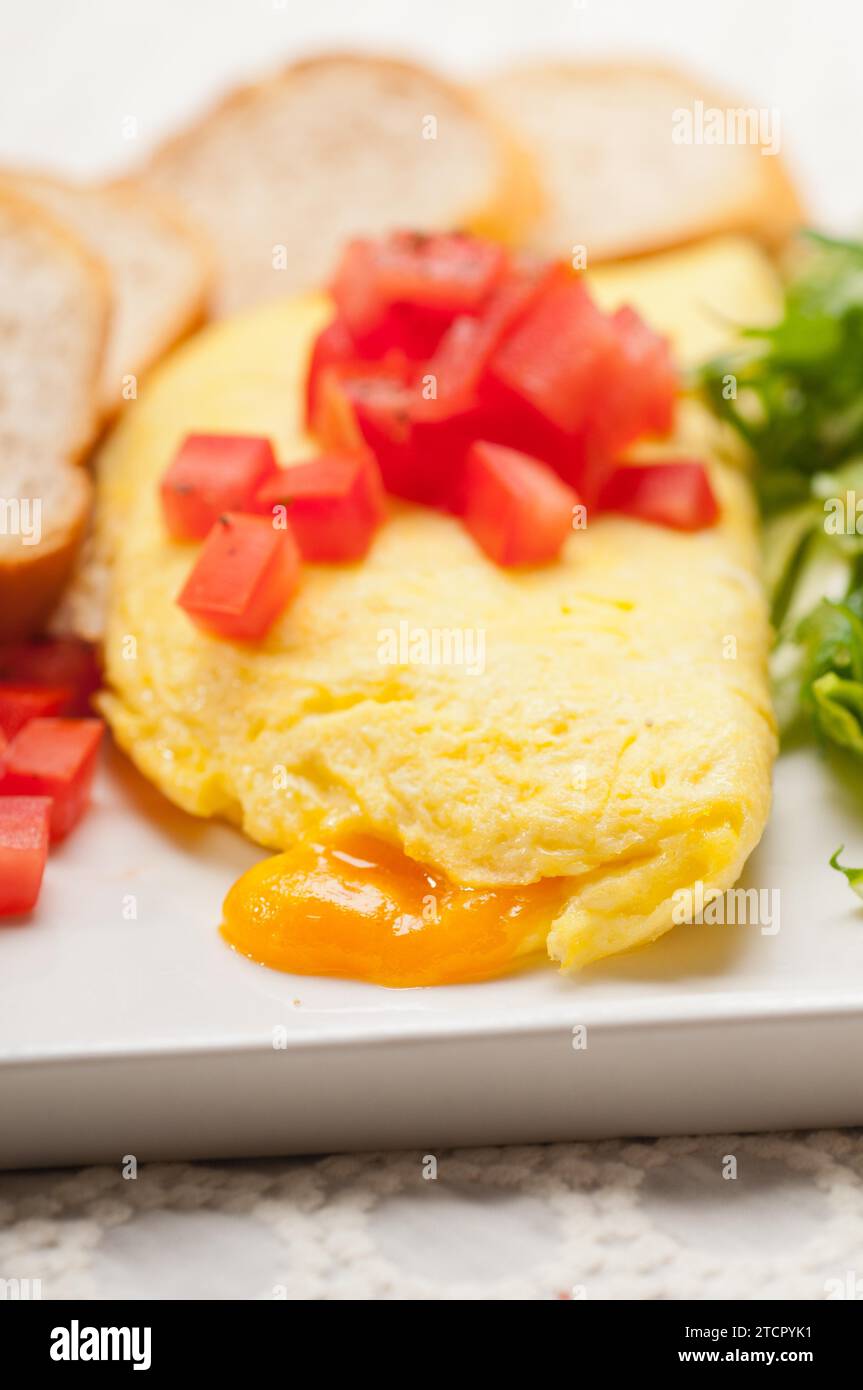 Home made omelette with cheese tomato and rucola rocket salad arugola Stock Photo