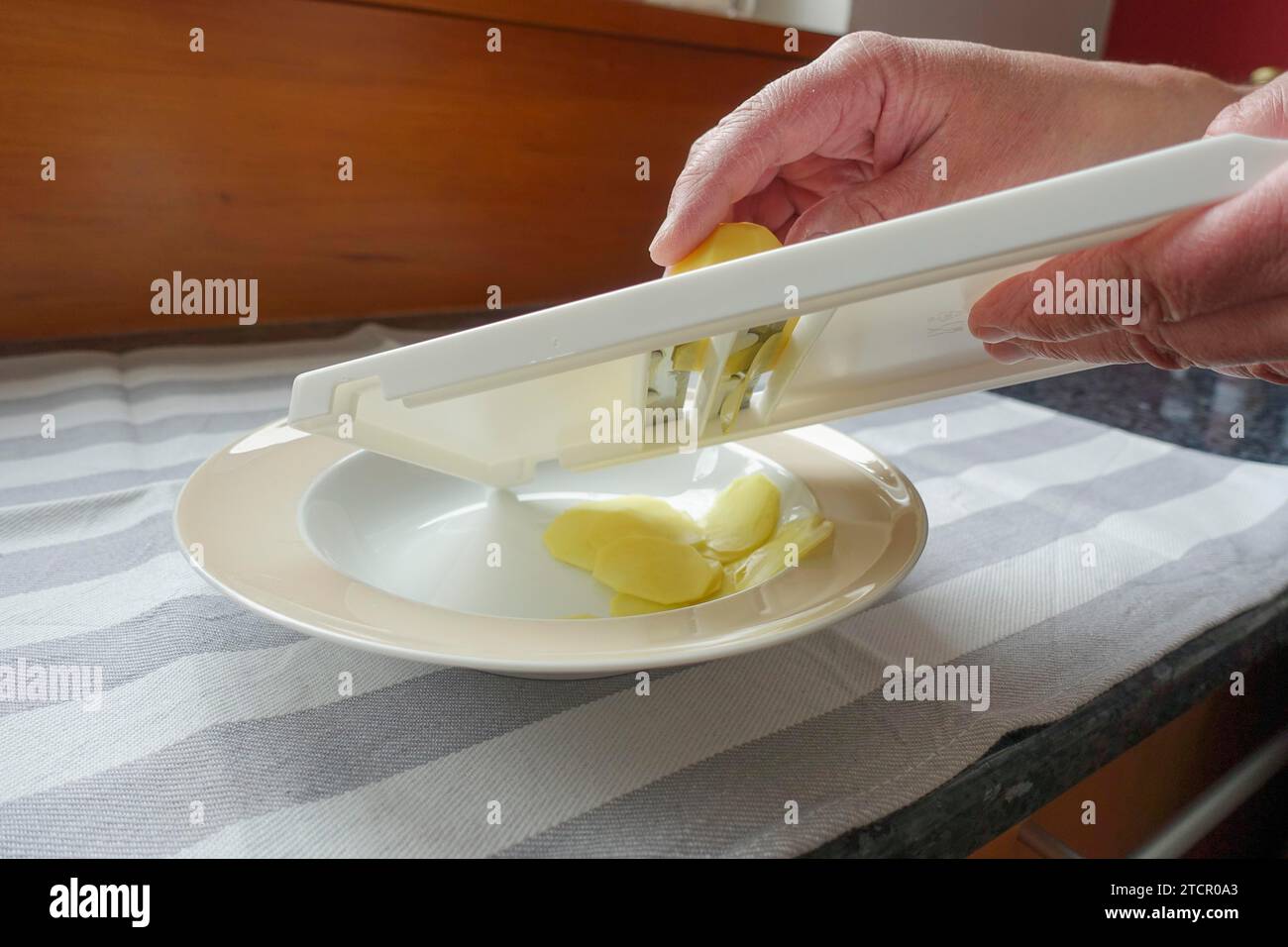 Preparation of cress soup with crisps, cutting potatoes, slicing, vegetable slicer, grating, Swabian cuisine, hearty soup, vegetarian, healthy Stock Photo