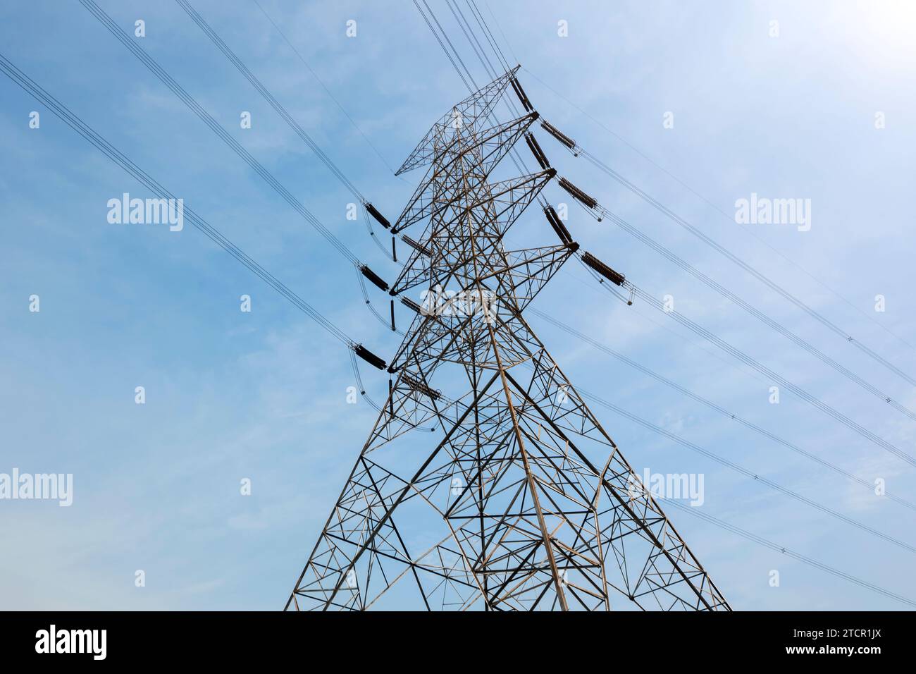 High voltage power lines tower with a blue sky background Stock Photo ...