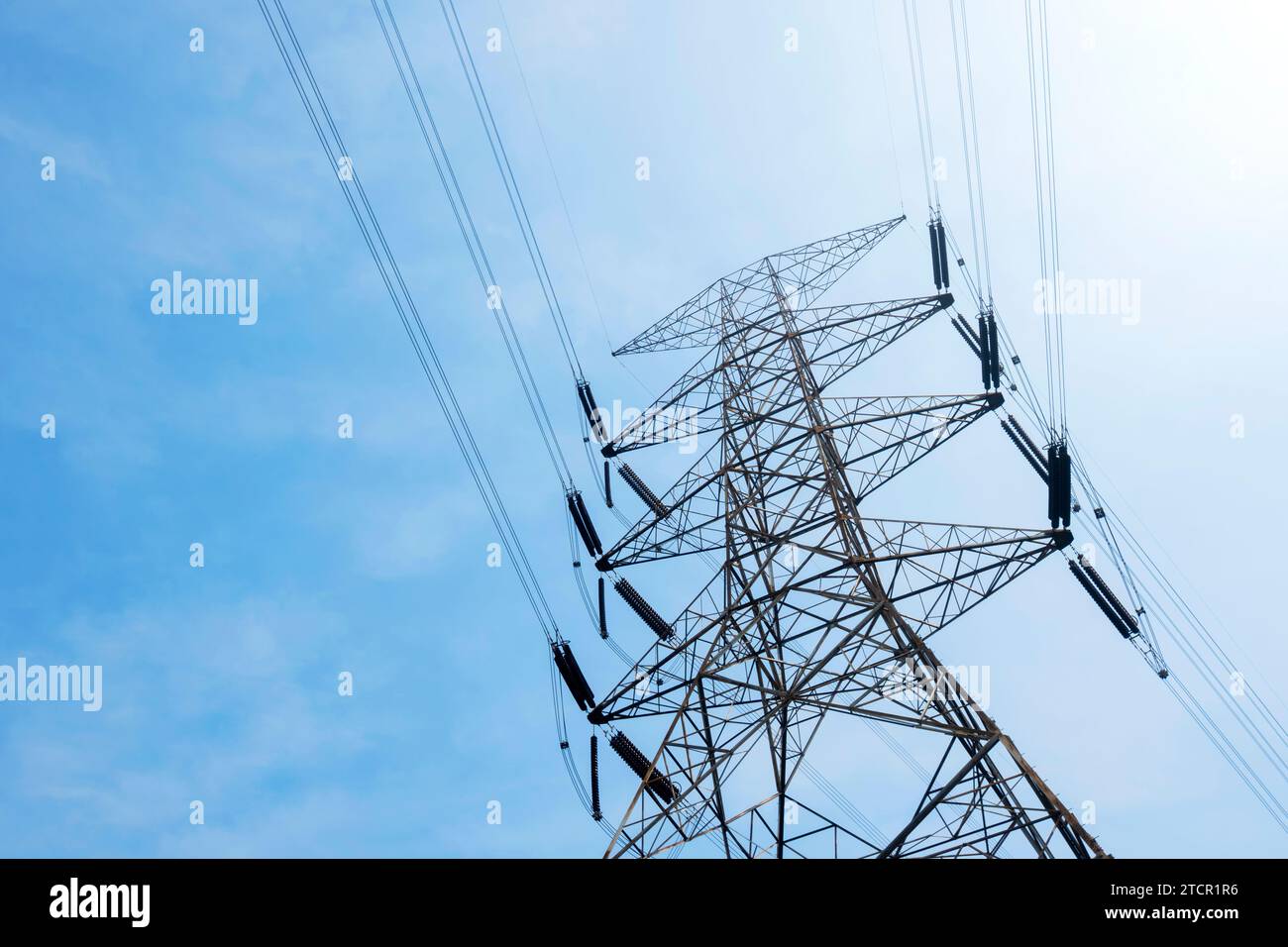 High voltage power lines tower with a blue sky background Stock Photo ...