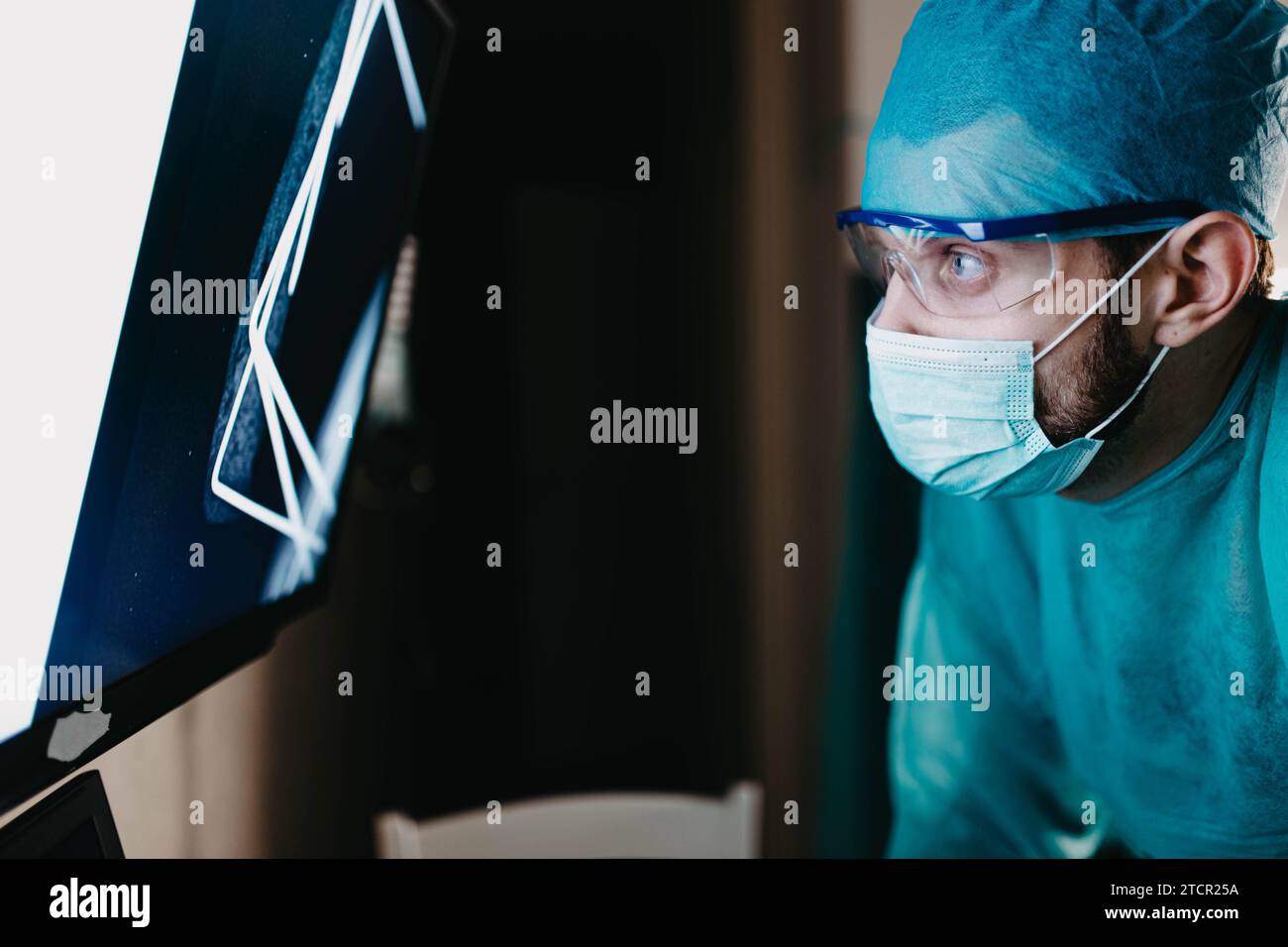 Male surgeon orthopedic traumatologist touches a touch screen with a x-ray of the bone Stock Photo