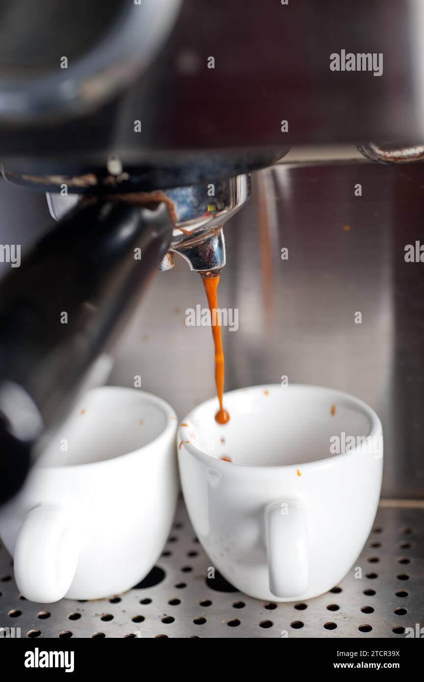 Italian espresso coffe making with professional machine macro Stock Photo