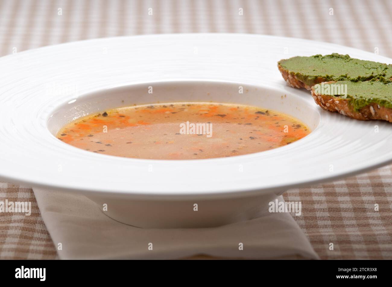 Classic Italian minestrone passato soup with pesto crostini on side