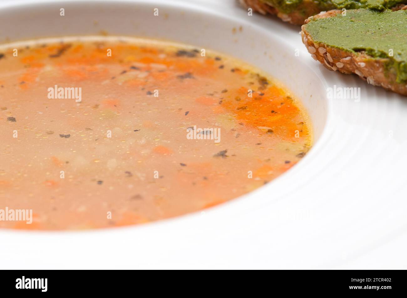 Classic Italian minestrone passato soup with pesto crostini on side