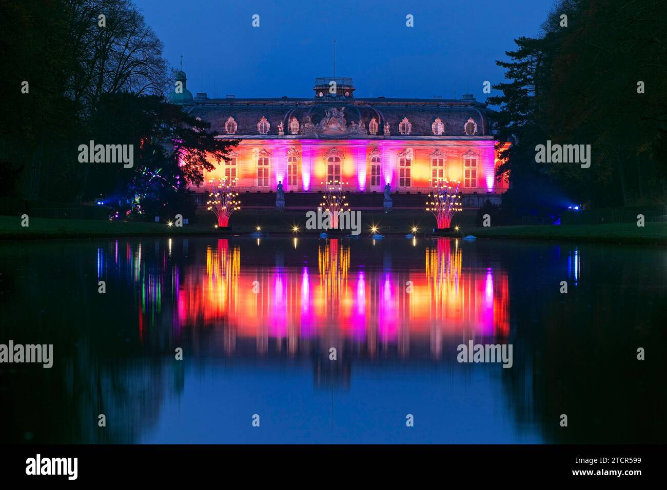 Illuminated Benrath Palace in the evening with the mirror pond at Christmas Wunderwelt, Duesseldorf, North Rhine-Westphalia, Germany Stock Photo