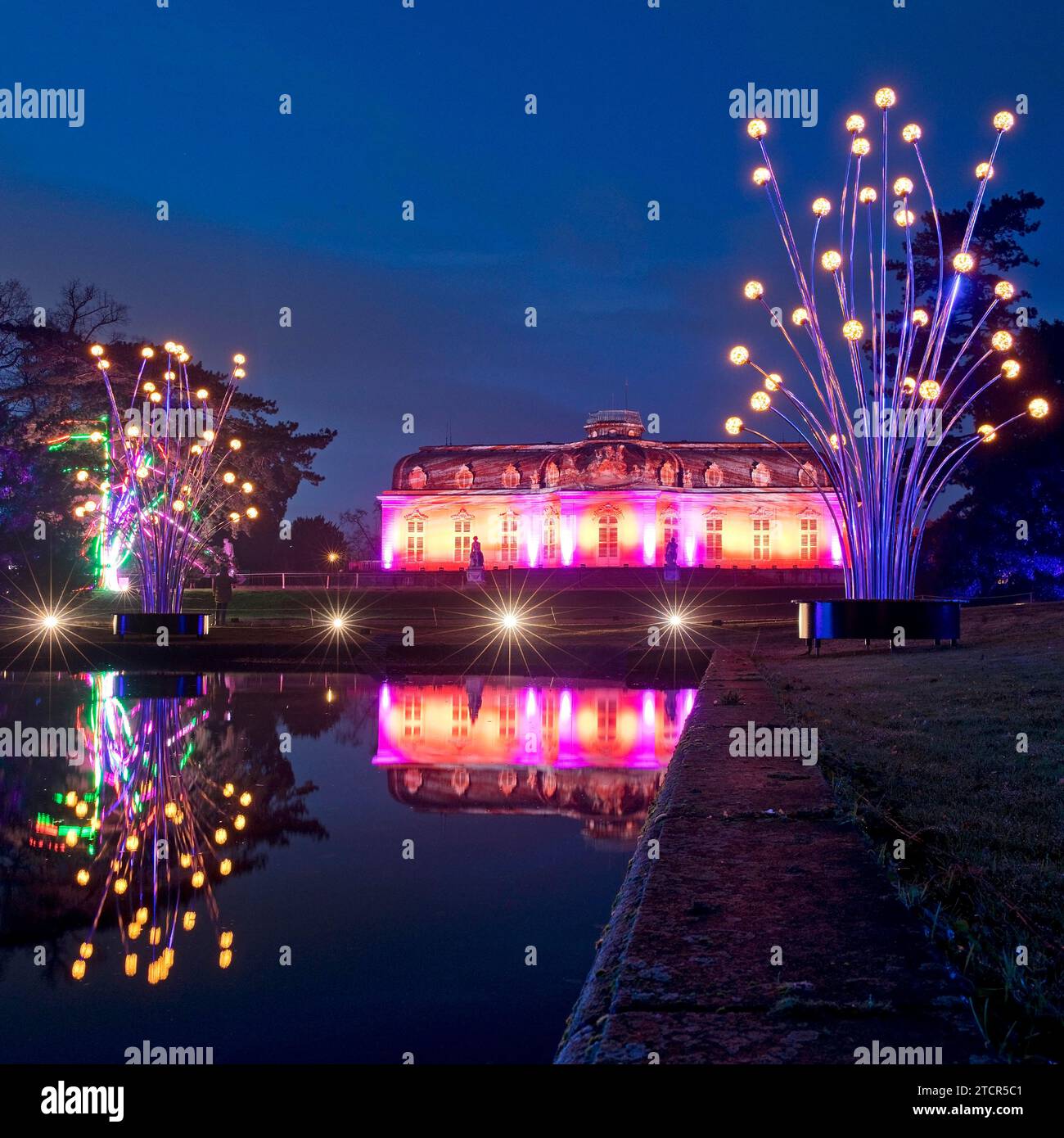 Illuminated Benrath Palace in the evening with the mirror pond at Christmas Wunderwelt, Duesseldorf, North Rhine-Westphalia, Germany Stock Photo
