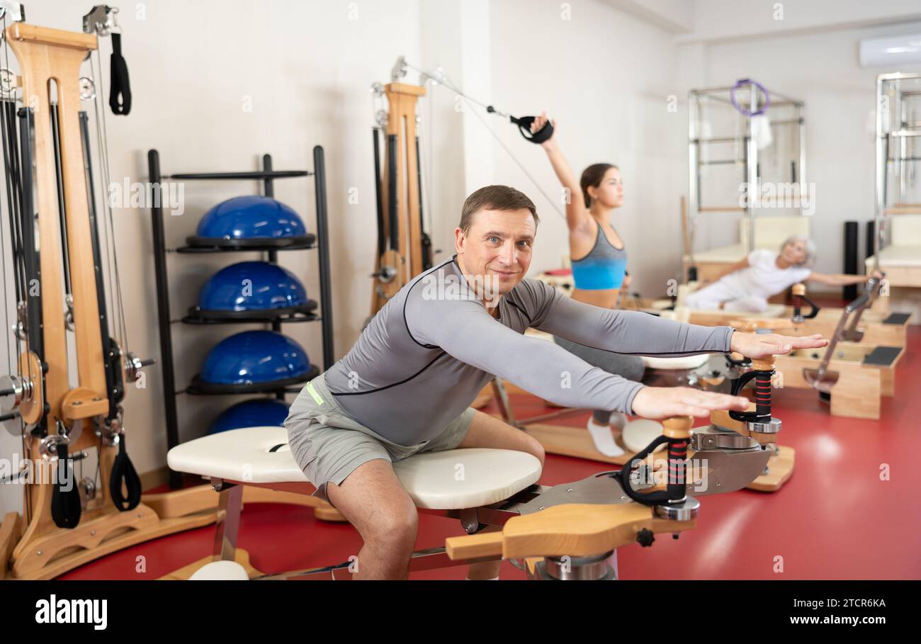 Man during Pilates training performs exercises and tasks on heron ...