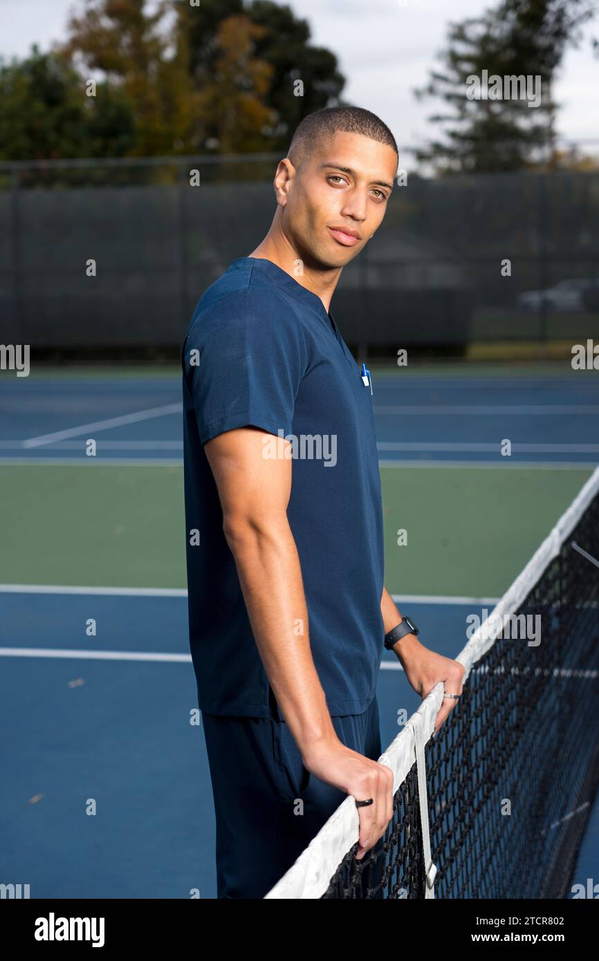 African American Doctor Wearing Scrubs Tennis Court in the Afternoon