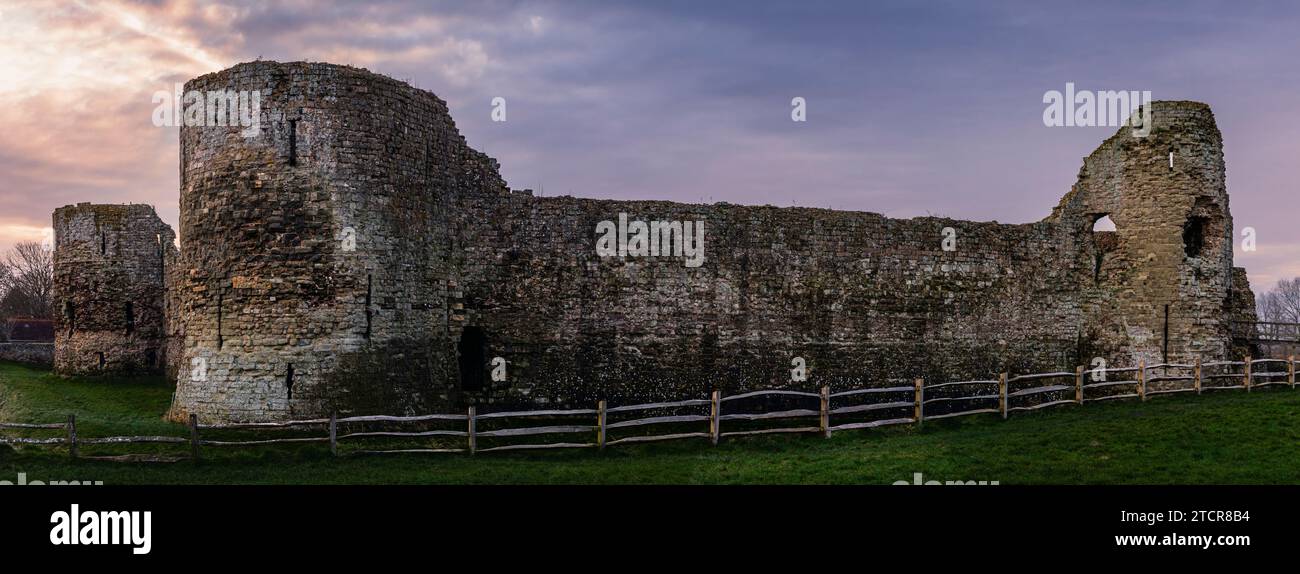 Panoramic eastward view of Pevensey castle just after December dawn near the east Sussex coast south east England UK Stock Photo