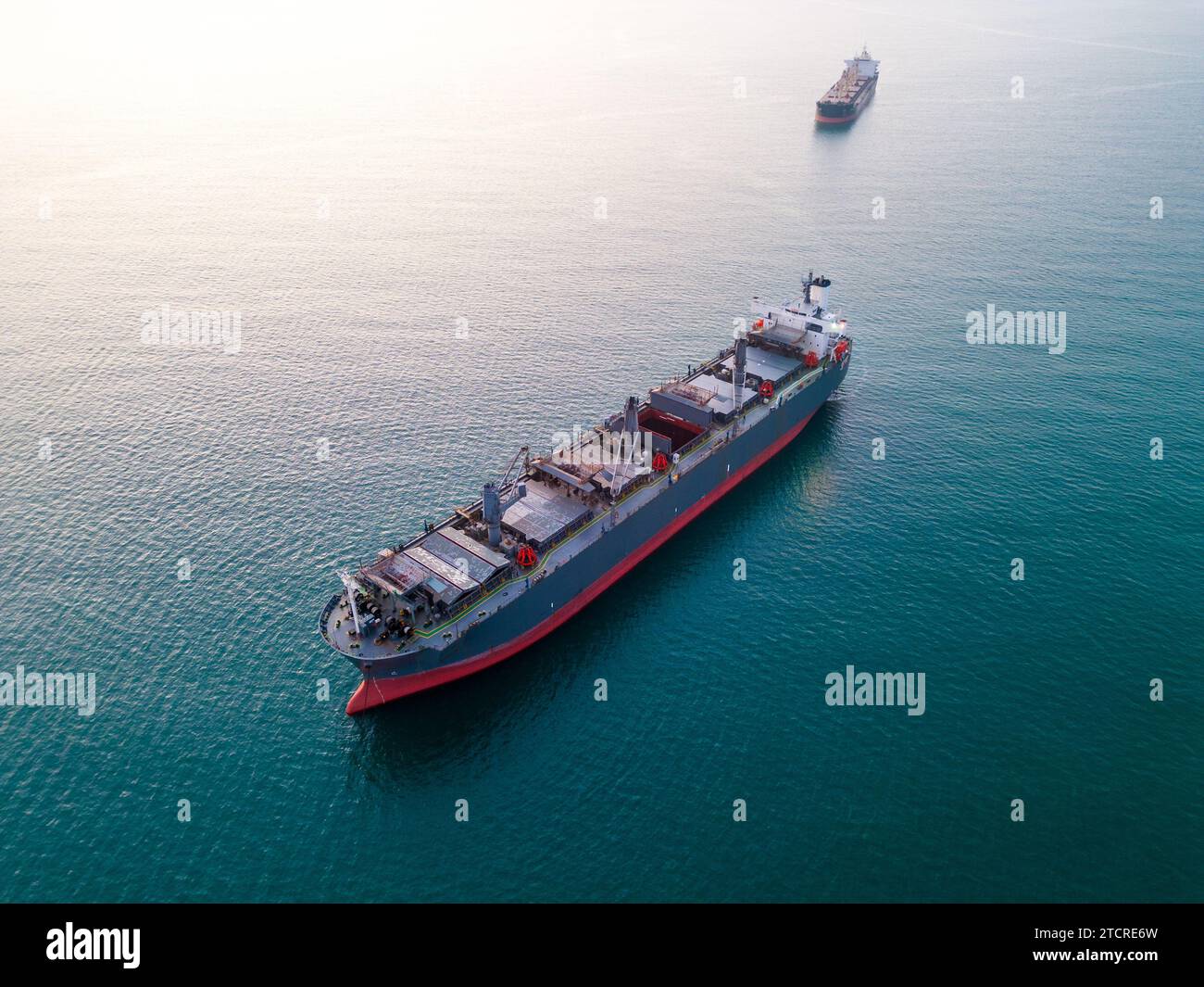 A massive cargo ship wood chips carrier in the sea, aerial view Stock
