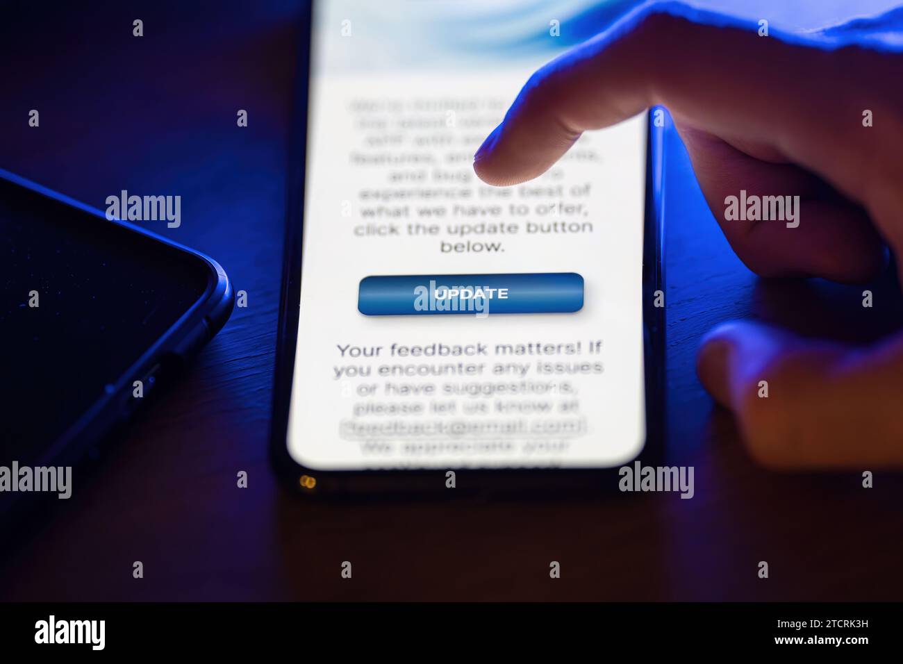 Clicking on update button on smartphone app Stock Photo