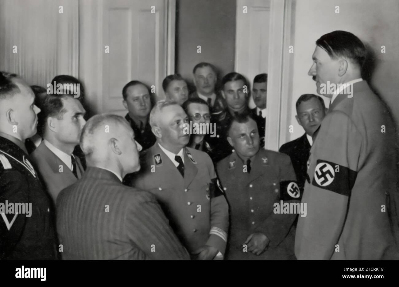 On the evening of the Reichstag elections on March 29, 1936, Adolf Hitler is seen surrounded by his closest associates. This moment captures the consolidation of power following a significant electoral event for the Nazi regime. The gathering of these key figures around Hitler, following a day marked by political maneuvering and propaganda, reflects the regime's strategy of unity and the central role of Hitler in orchestrating and leading these efforts. Stock Photo