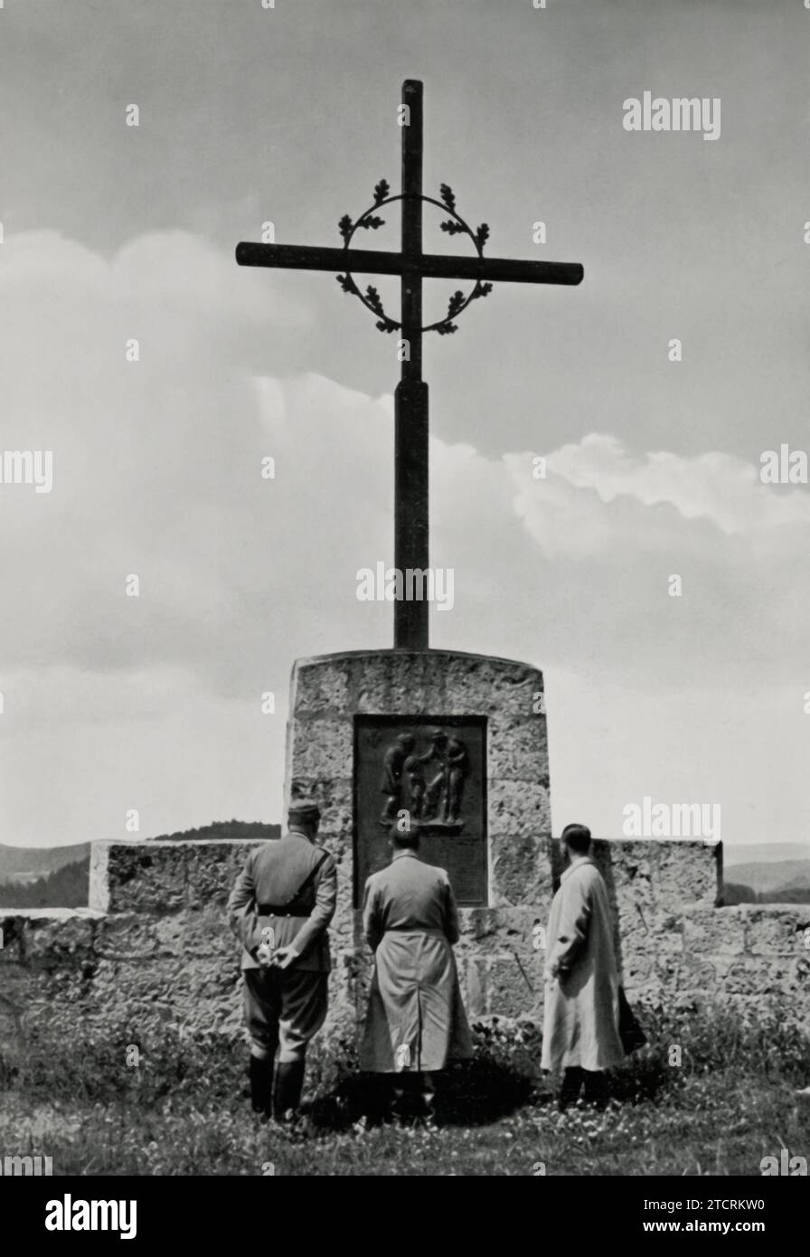 Adolf Hitler is shown in this photograph visiting the war memorial in Hiltpoltstein, Franconian Switzerland, captured in the image titled 'Der Führer in Franklen.' The moment highlights a propagandistic display of remembrance and patriotism, with Hitler's presence at this significant site serving to reinforce the Nazi regime's narrative. Stock Photo