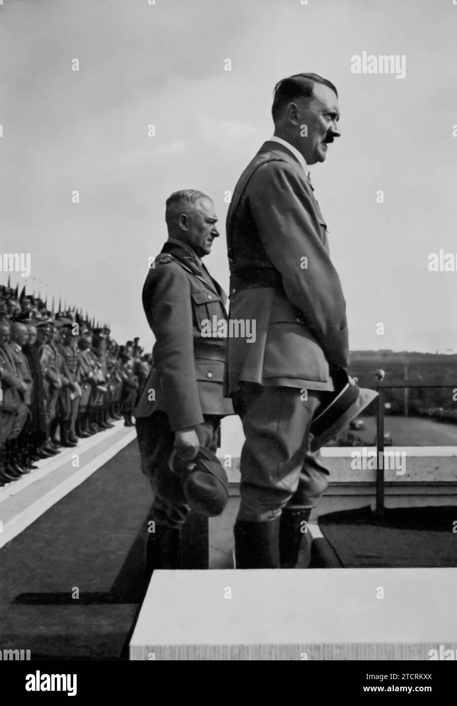 Adolf Hitler is shown alongside Reich Labour Leader Konstantin Hierl in front of 47,000 laborers at the 1935 Reichsparteitag (Nazi Party Rally). This gathering was a significant display of organized labor under the Nazi regime, with the massive assembly of workers symbolizing unity and strength. The presence of Hitler and Hierl at this event highlights the regime's emphasis on labor as a key component of its social and economic policies. Stock Photo