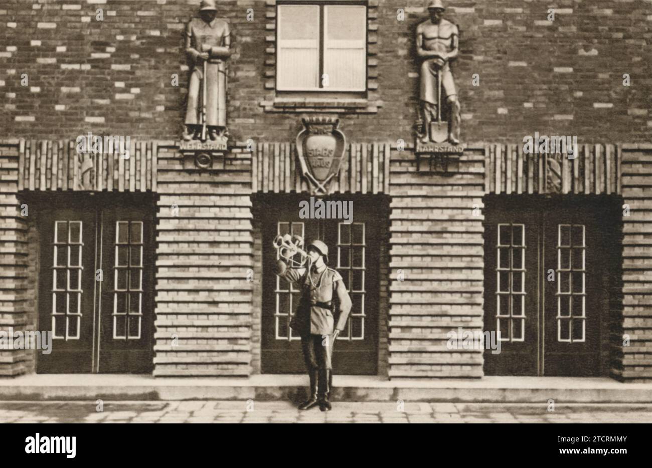A German soldier plays the trumpet at 5 o'clock in the morning, serving as a wakeup call at the