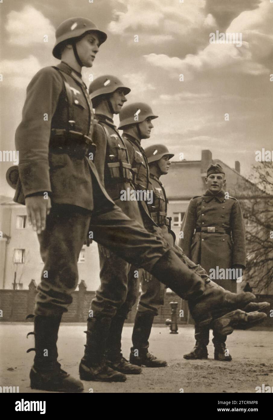 German recruits, in the midst of their training, are shown the correct