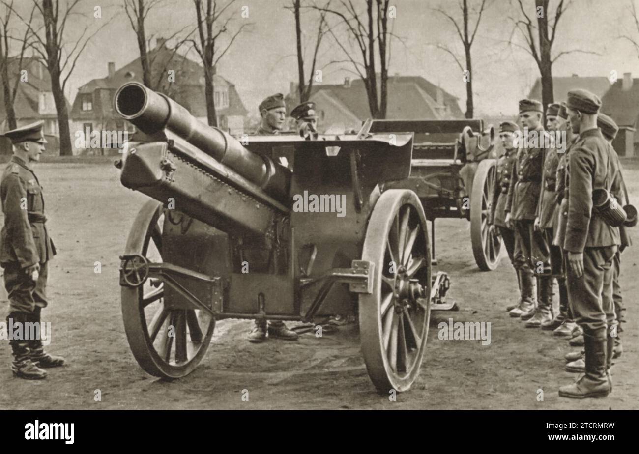 German recruits are shown during a significant moment in their military training: their first introduction to large artillery cannons. This initial encounter is crucial for familiarizing them with the size, mechanics, and operation of these powerful weapons. Stock Photo