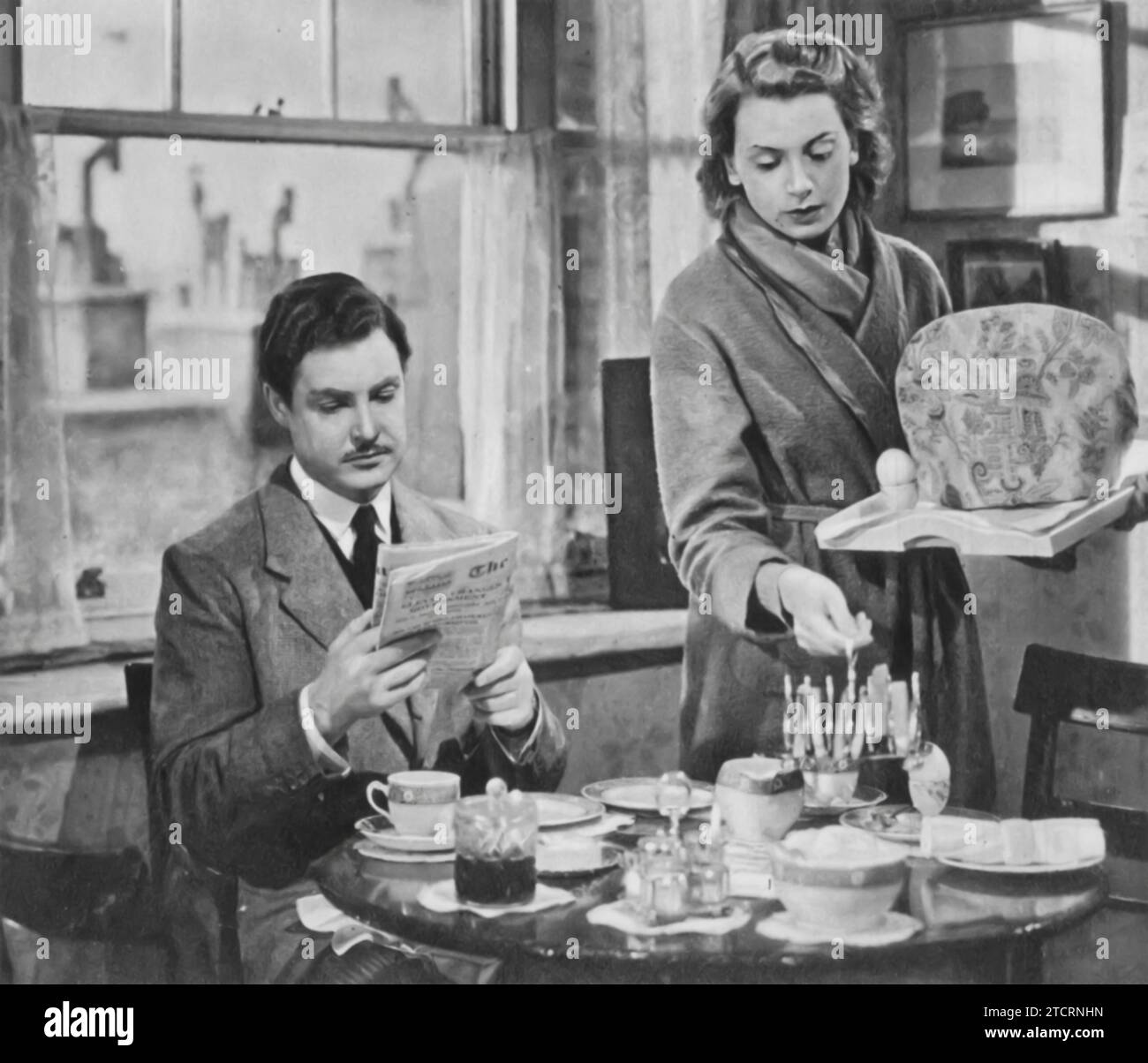 Robert Donat and Deborah Kerr star in 'Perfect Strangers' (1945). The film delves into the lives of a married couple who, after being separated during World War II, meet again and struggle with the changes each has undergone, re-evaluating their relationship in the process. Stock Photo