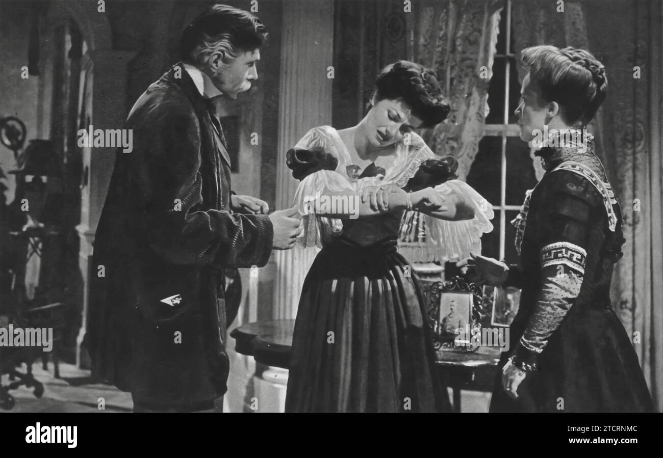 James Mason, Margaret Lockwood, and Barbara Mullen in 'A Place of One's Own' (1945). The film delves into the mysterious and suspenseful tale of a couple who move into a house that may be haunted. Lockwood plays a young woman possessed by the spirit of a previous tenant, with Mason and Mullen portraying the couple who grapple with the eerie occurrences. Stock Photo