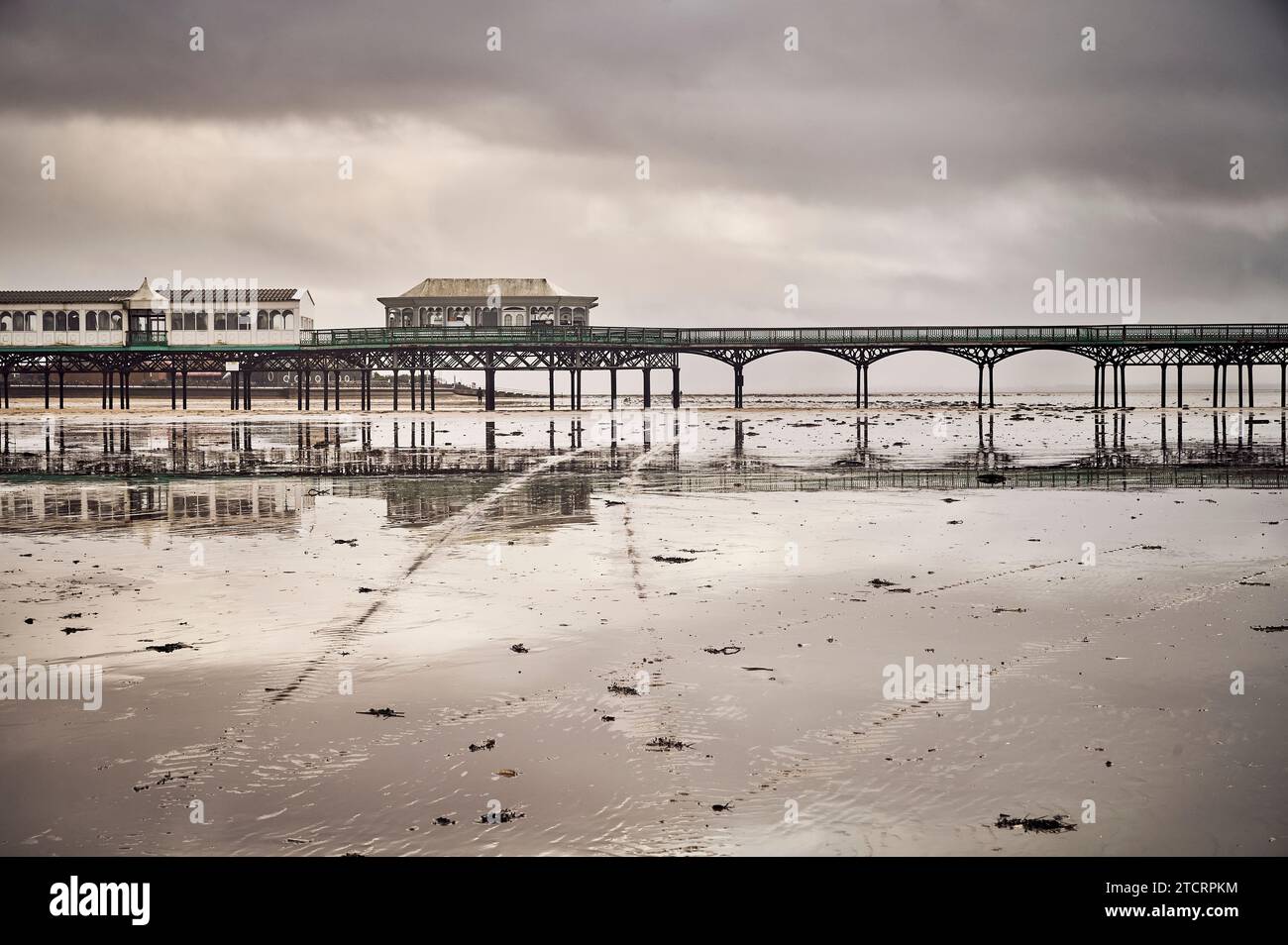 St Annes pier reflected in the wet beach in winter Stock Photo