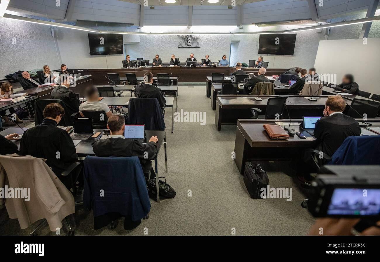 Stuttgart, Germany. 14th Dec, 2023. Five men are on trial at Stuttgart Regional Court for attempted manslaughter and causing grievous bodily harm. They allegedly punched and kicked a suspected grenade thrower, who had fled after throwing a hand grenade at a funeral service at a cemetery in Altbach, in a cab waiting for him and dragged him out of the cab. Credit: --/dpa - ATTENTION: Person(s) has/have been pixelated for legal reasons/dpa/Alamy Live News Stock Photo