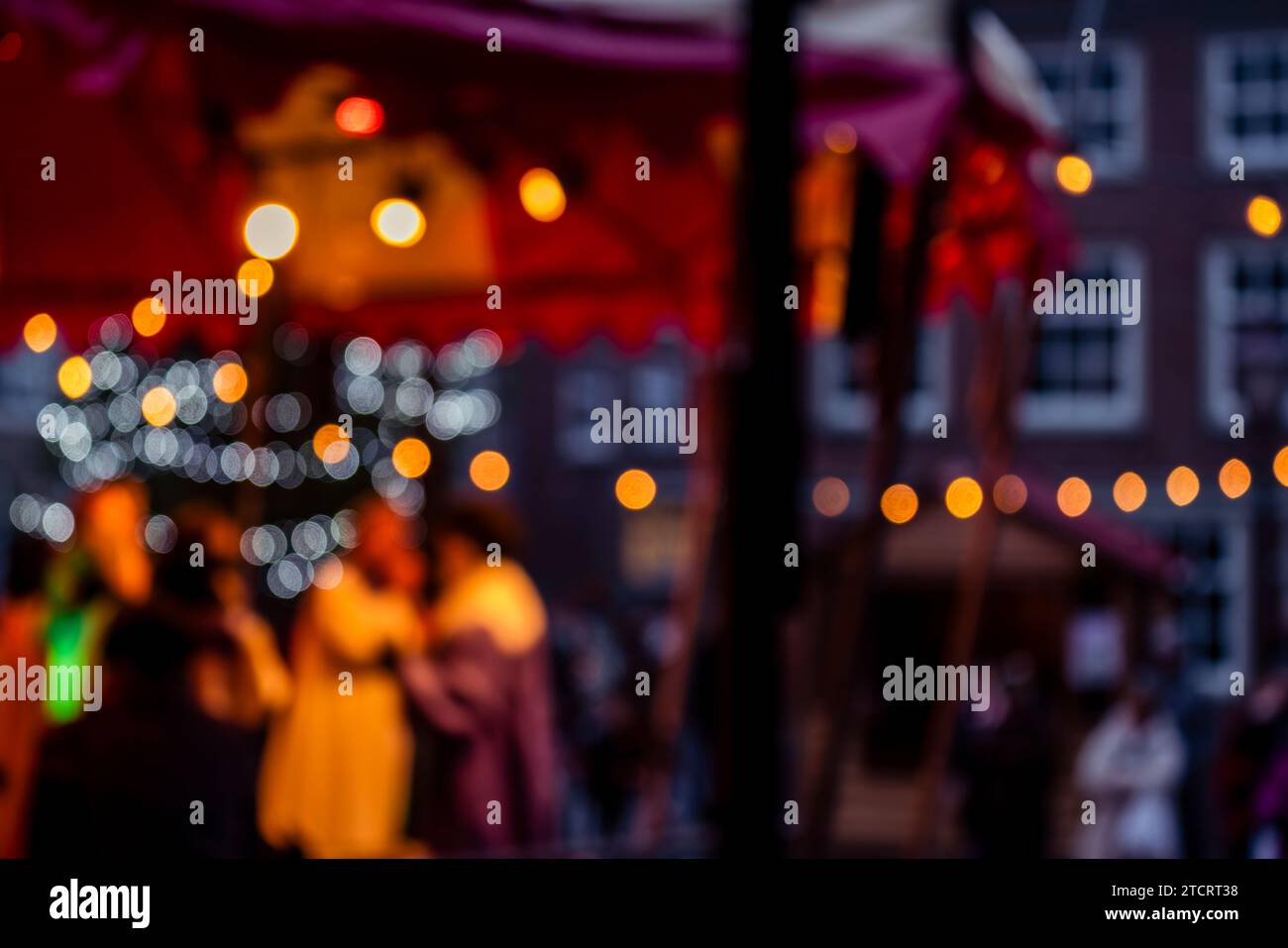 Immerse yourself in the festive spirit with this charming Christmas street market scene. Bokeh lights festive stalls and a cozy ambiance. Perfect for Stock Photo