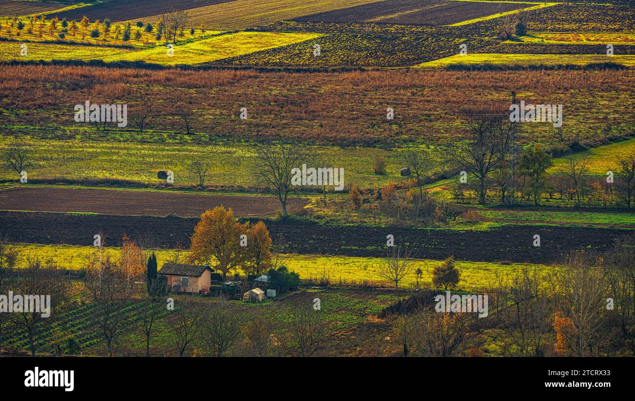 Cultivated fields with a farm illuminated by early morning light. Abruzzo, Italy, Europe Stock Photo