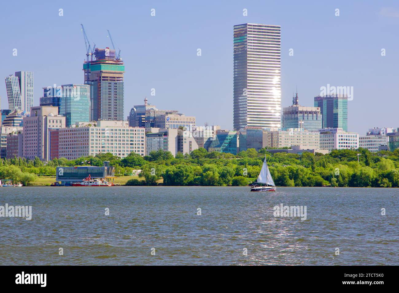 Seoul, South Korea - June 3, 2023: A view from Mangwon Hangang Park captures Yeouido Island, featuring a gleaming tower, a half-constructed building, Stock Photo