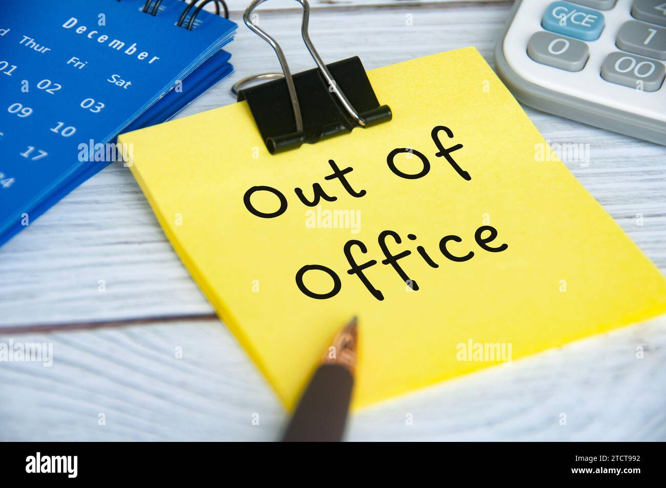 Out of office text on sticky notepad with December calendar and
