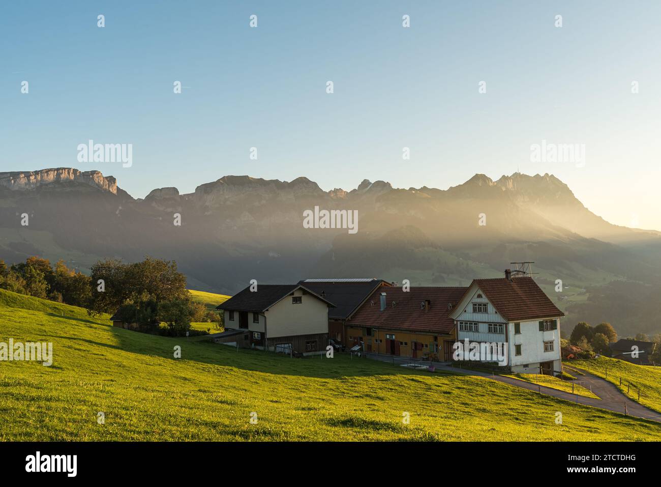Lonely farm house in the Appenzell Alps in front of the Alpstein mountains with Saentis, Canton of Appenzell Innerrhoden, Switzerland Stock Photo